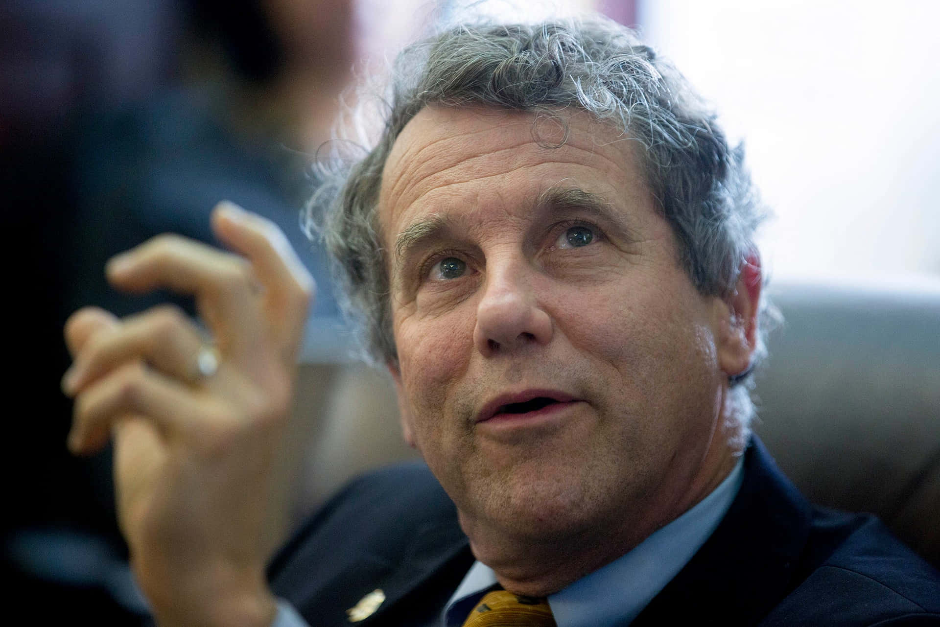 Sherrod Brown Talking With Assistant Background