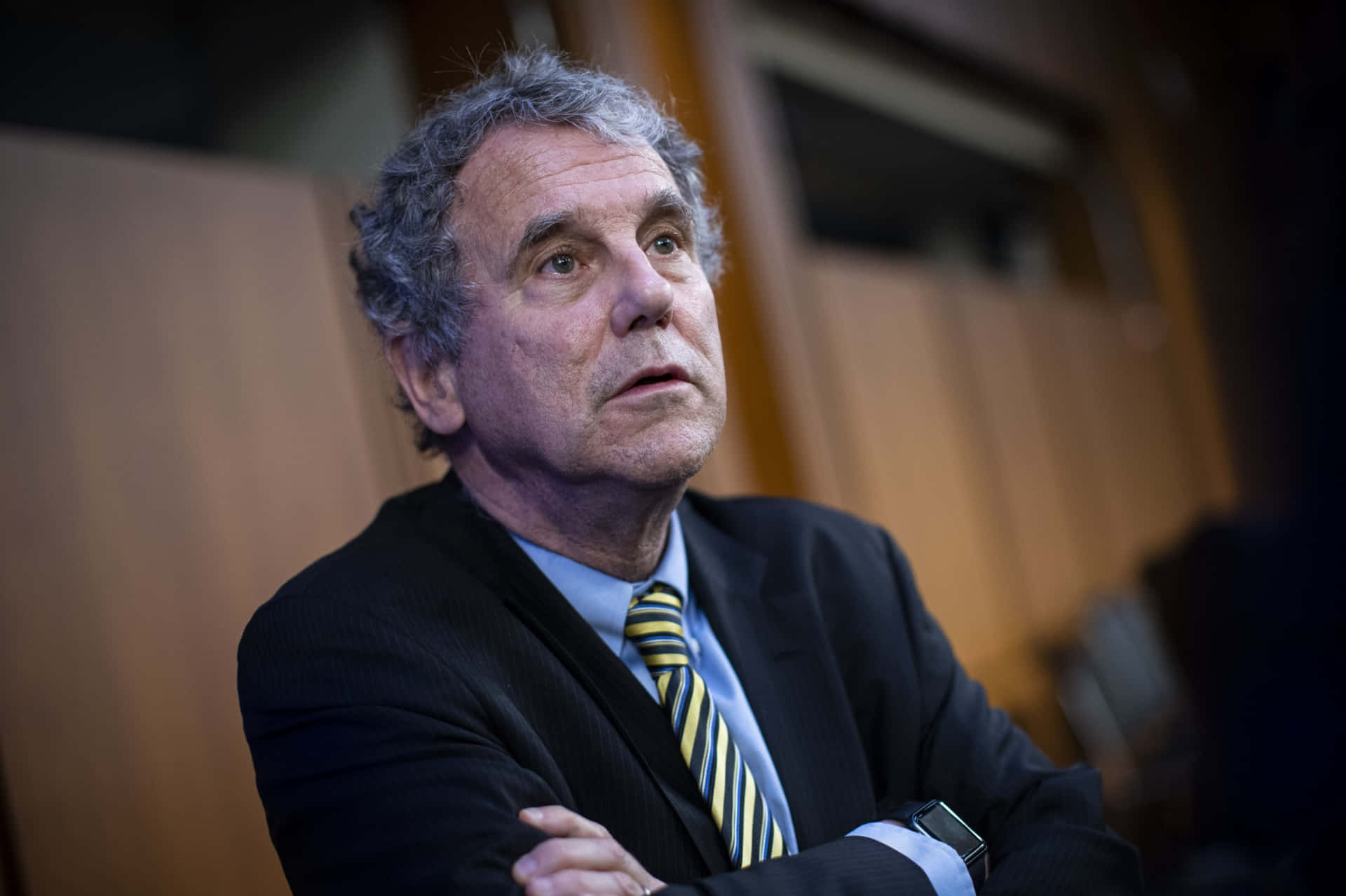 Sherrod Brown With Crossed Arms Background