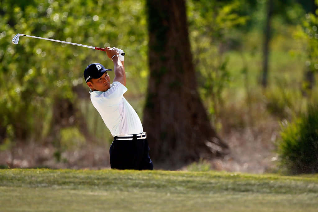 Shigeki Maruyama Actively Competing On The Golf Course.
