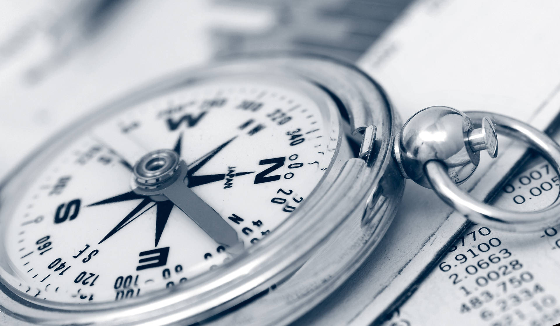 Shiny Metal Compass On A Paper Background