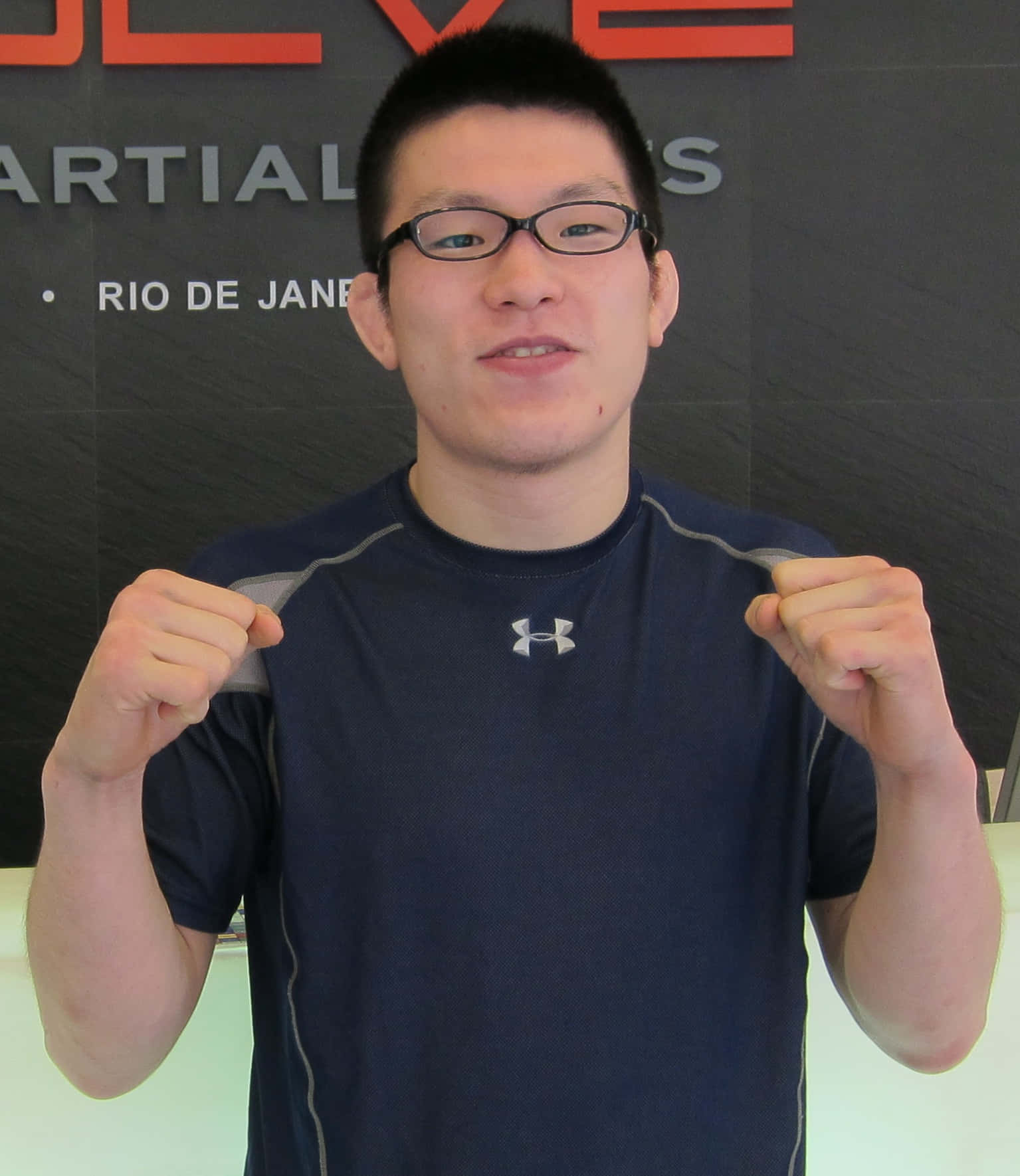 Shinya Aoki, A Dominating Force In Mixed Martial Arts, Posing In His 2011 Evolve Mma Gear. Background