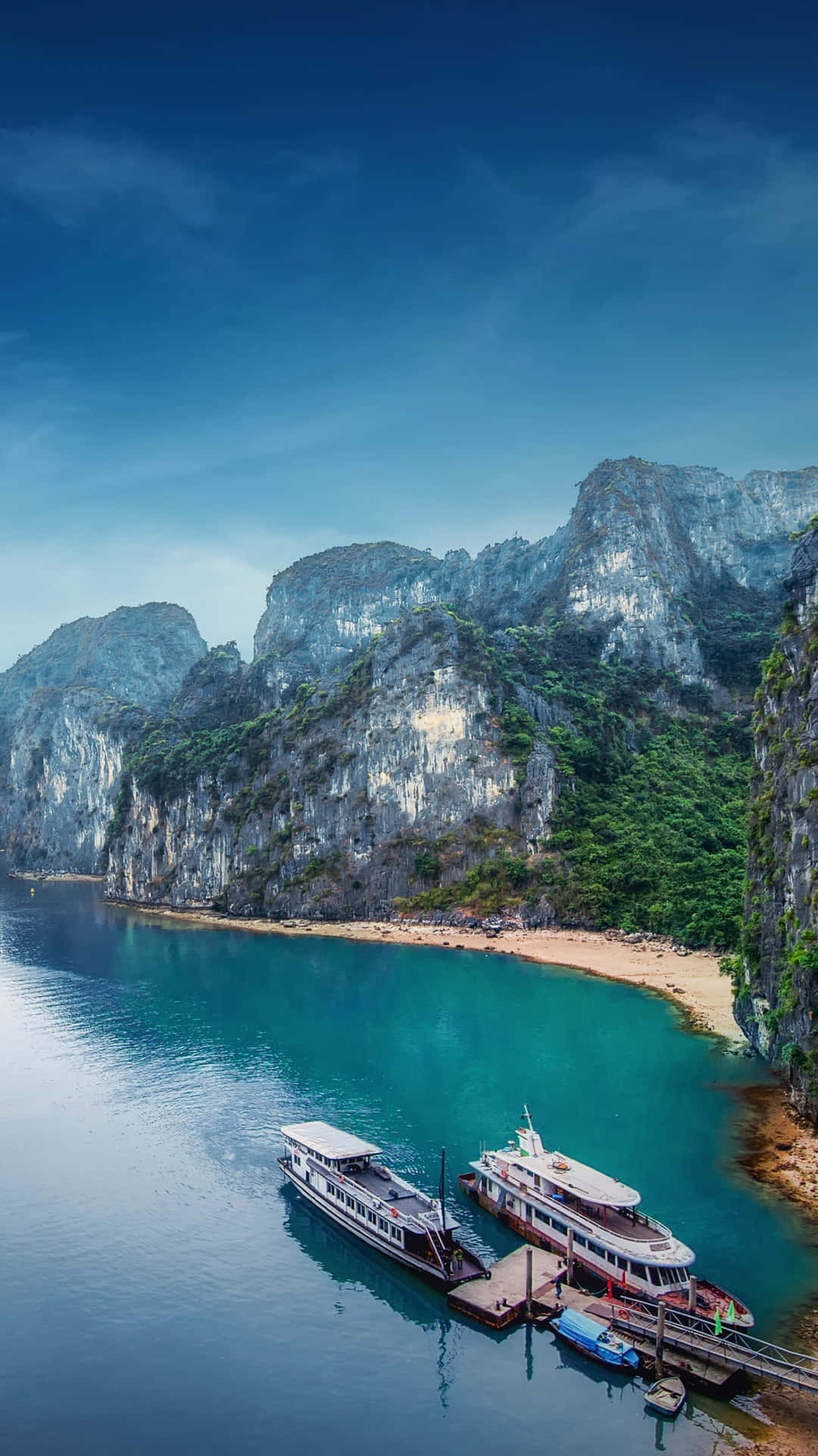 Ships Docked Near Halong Bay's Shore Background