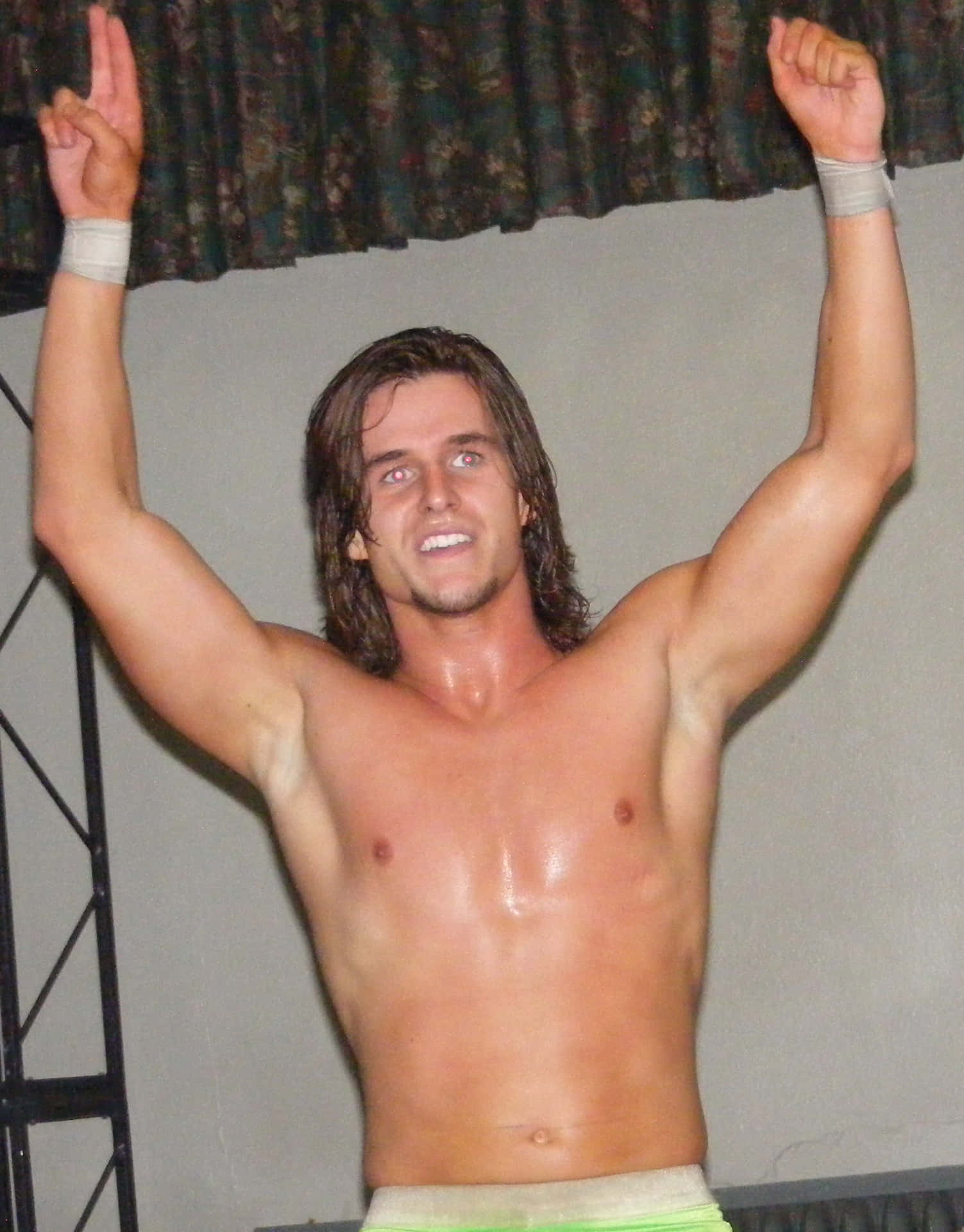 Shirtless Young Adam Cole With His Hands Up Background
