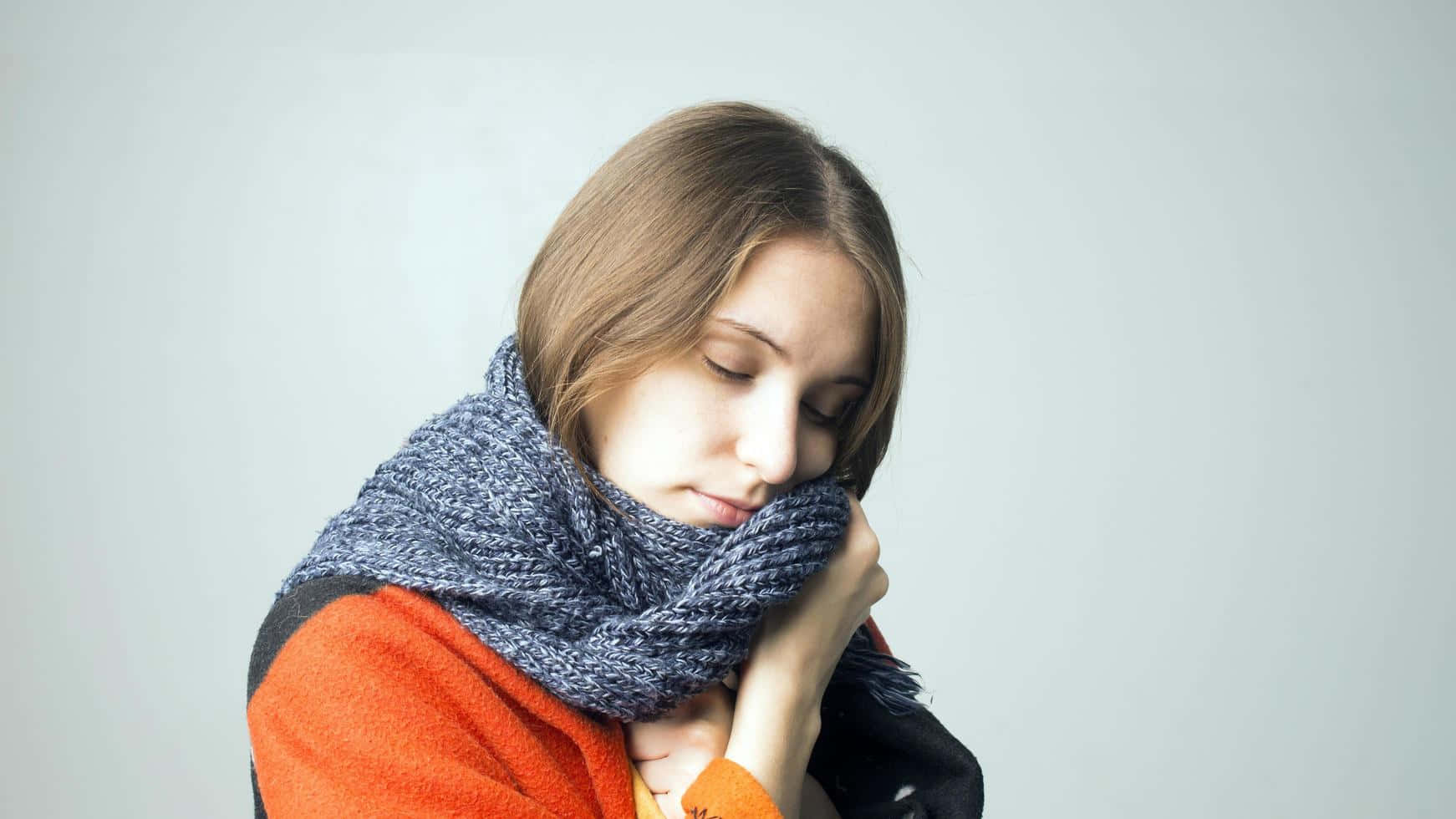 Shivering Woman Holding Scarf [wallpaper] Background