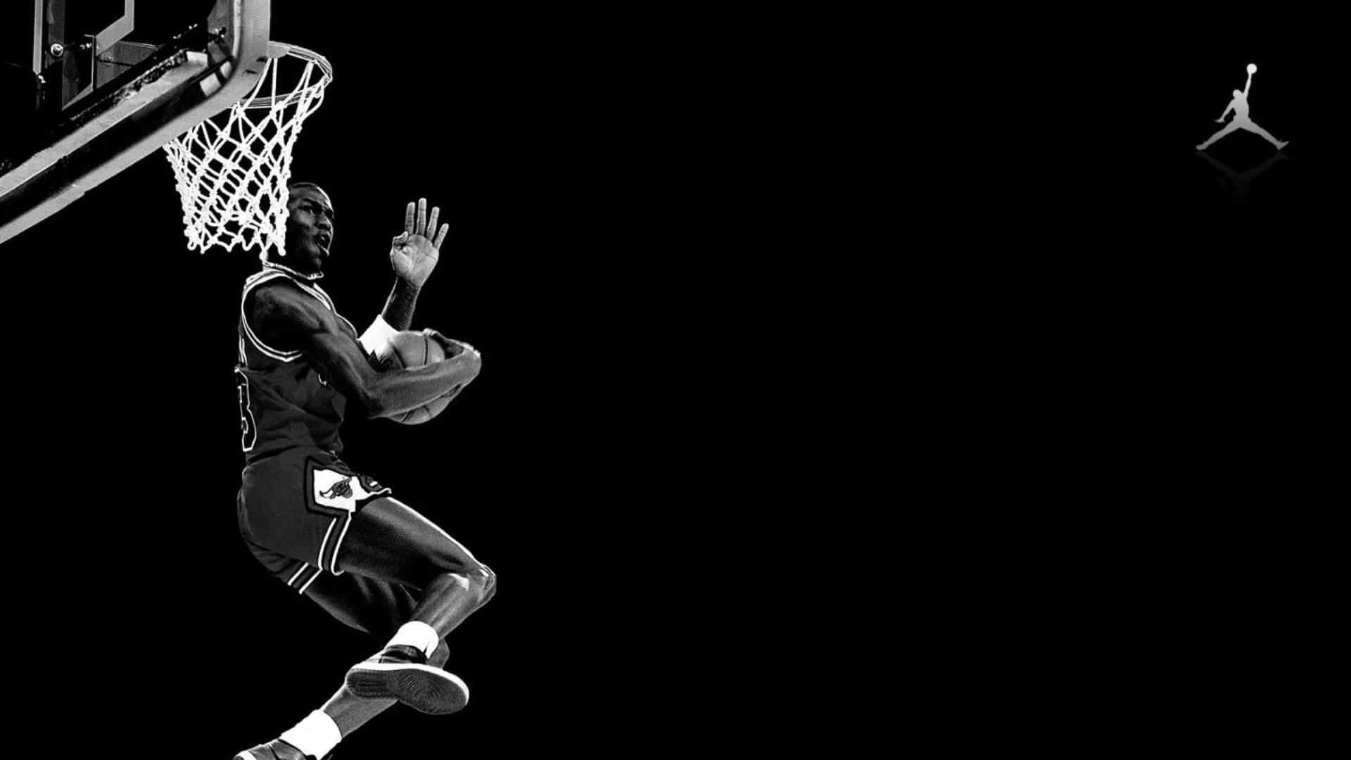 Shooting Michael Jordan With Jordan Logo Background