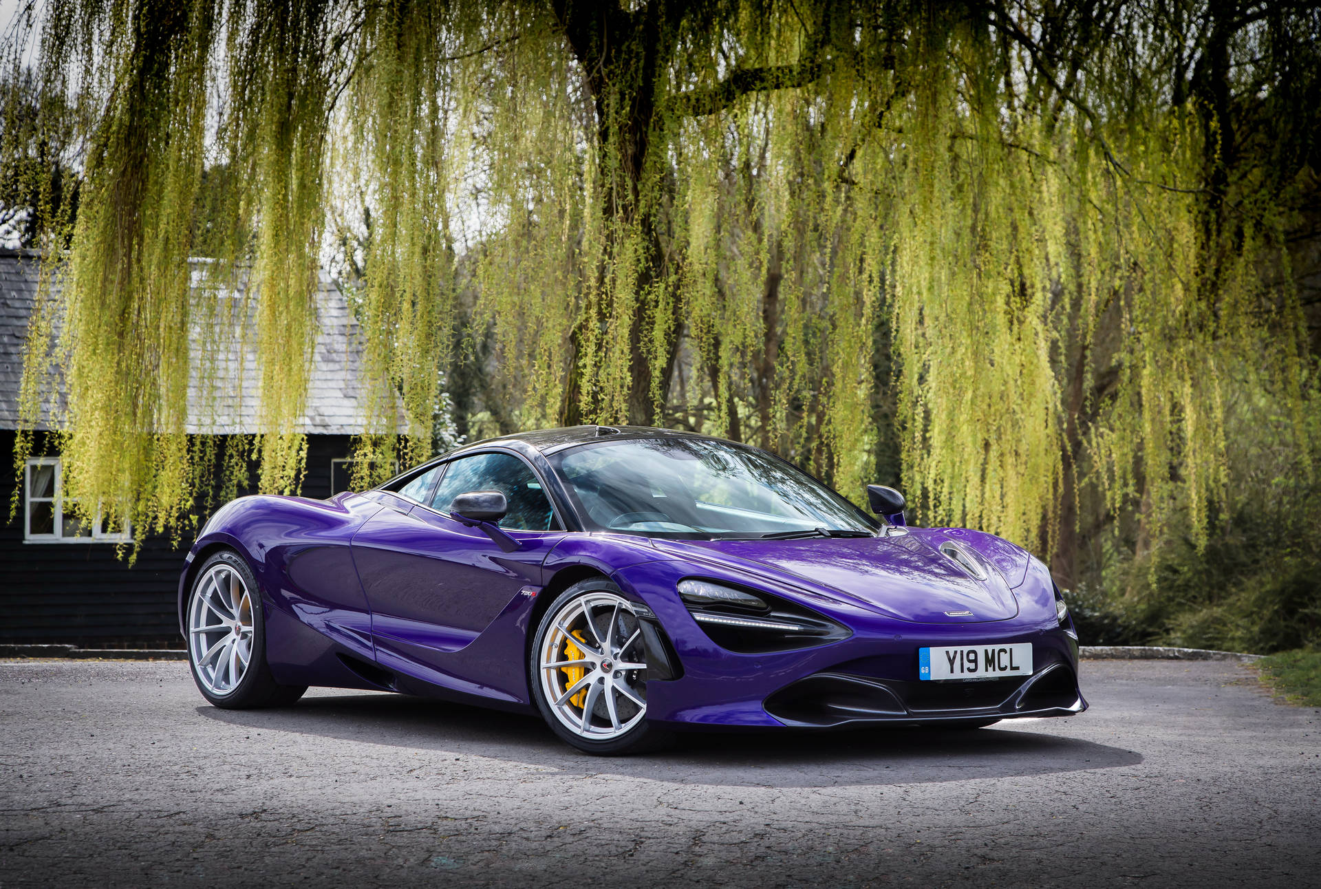 Showcasing Power And Luxury: The Stunning Mclaren 720s In Violet Background