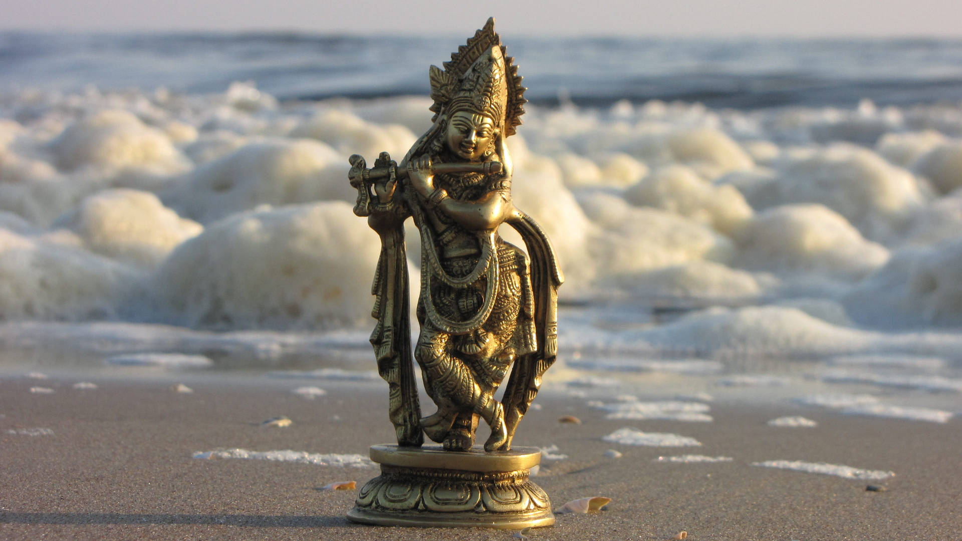 Shri Krishna Statue On Sand Background