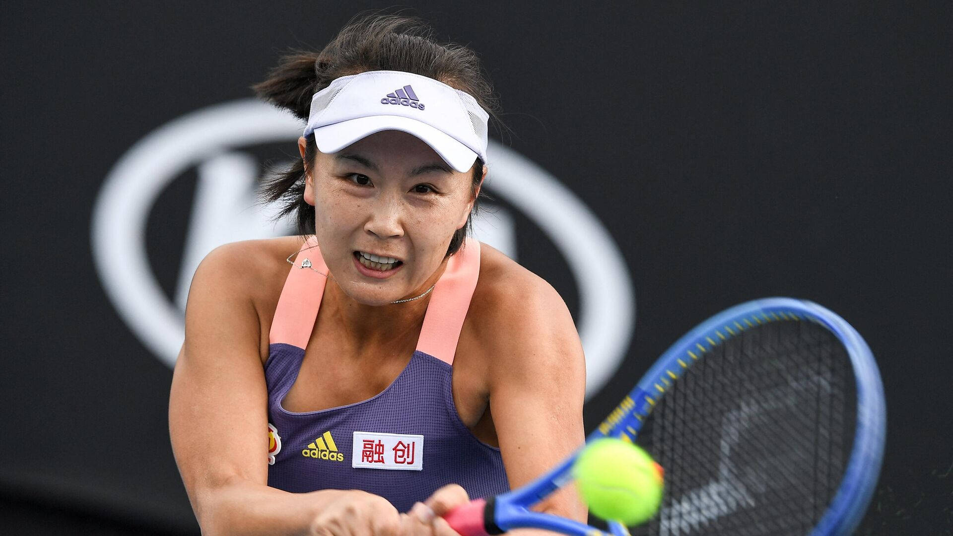 Shuai Peng Powerfully Smashing A Tennis Ball Background