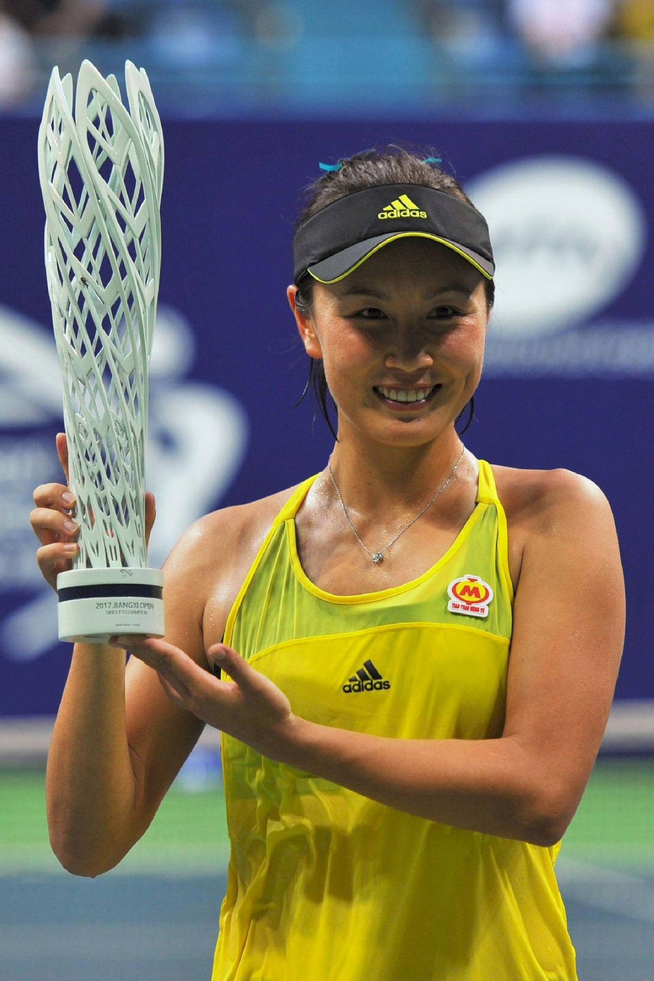 Shuai Peng Triumphantly Holding Tennis Trophy