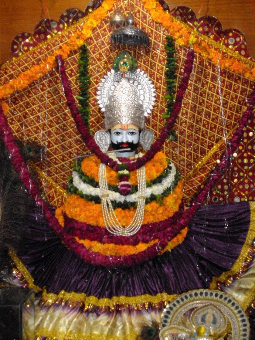 Shyam Baba Statue With Colorful Garlands Background