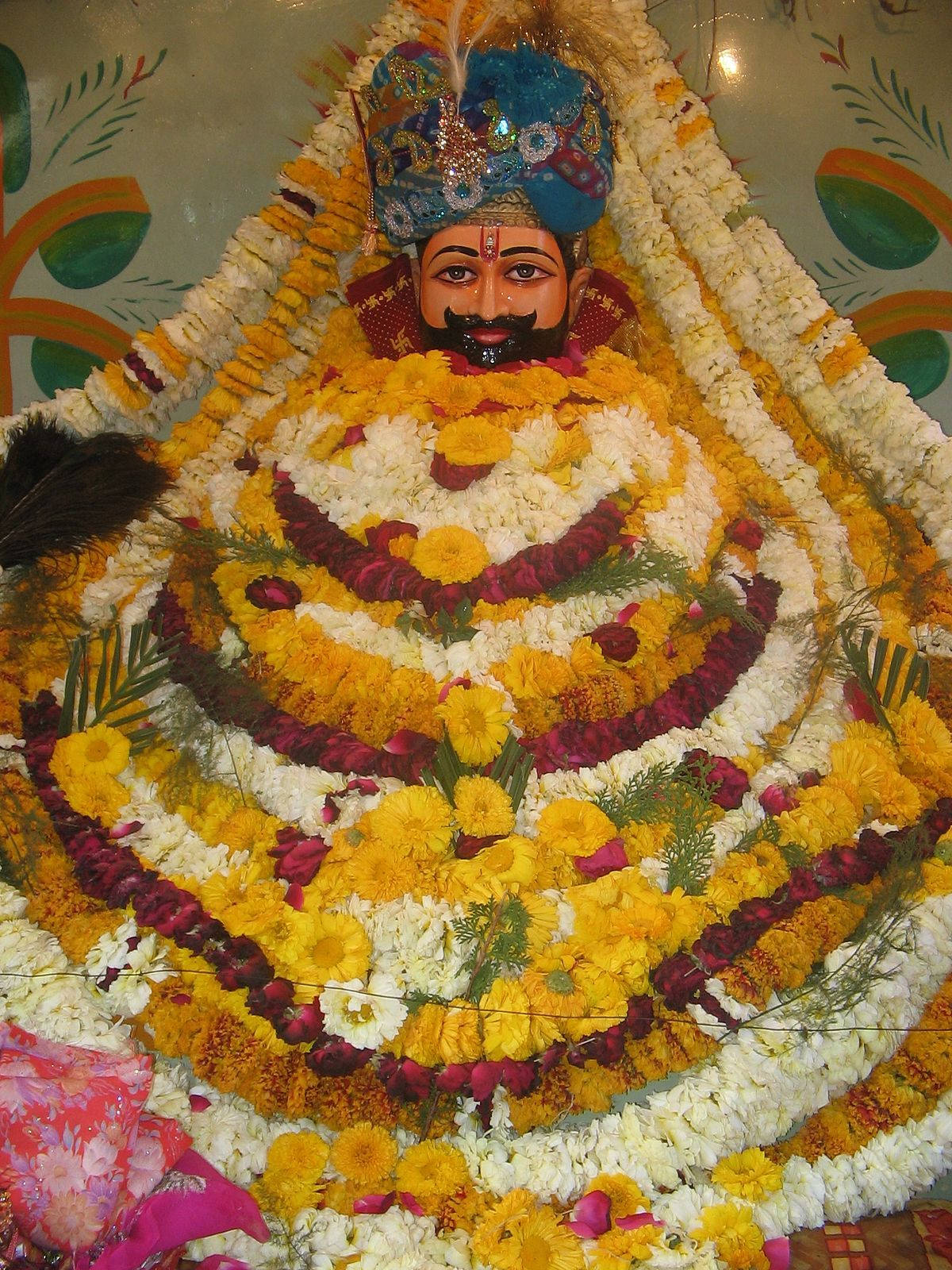 Shyam Baba Statue With Yellow Garlands Background