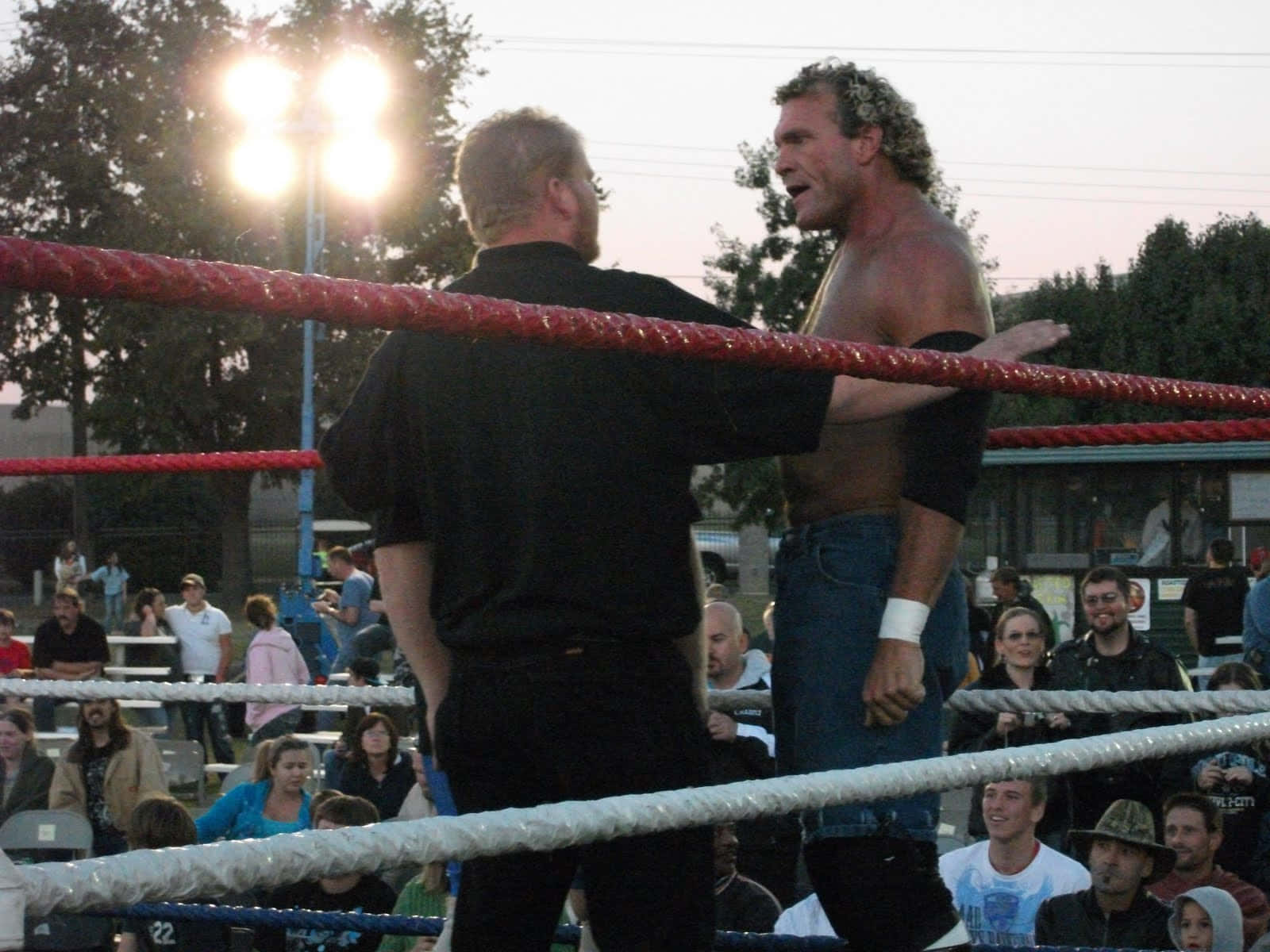Sid Vicious Wrestling In The Ring With A Referee Background