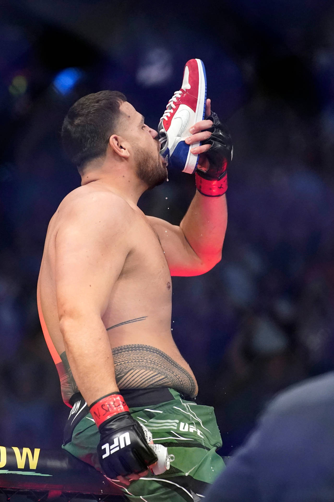 Side Photo Of Tai Tuivasa Drinking From Shoe