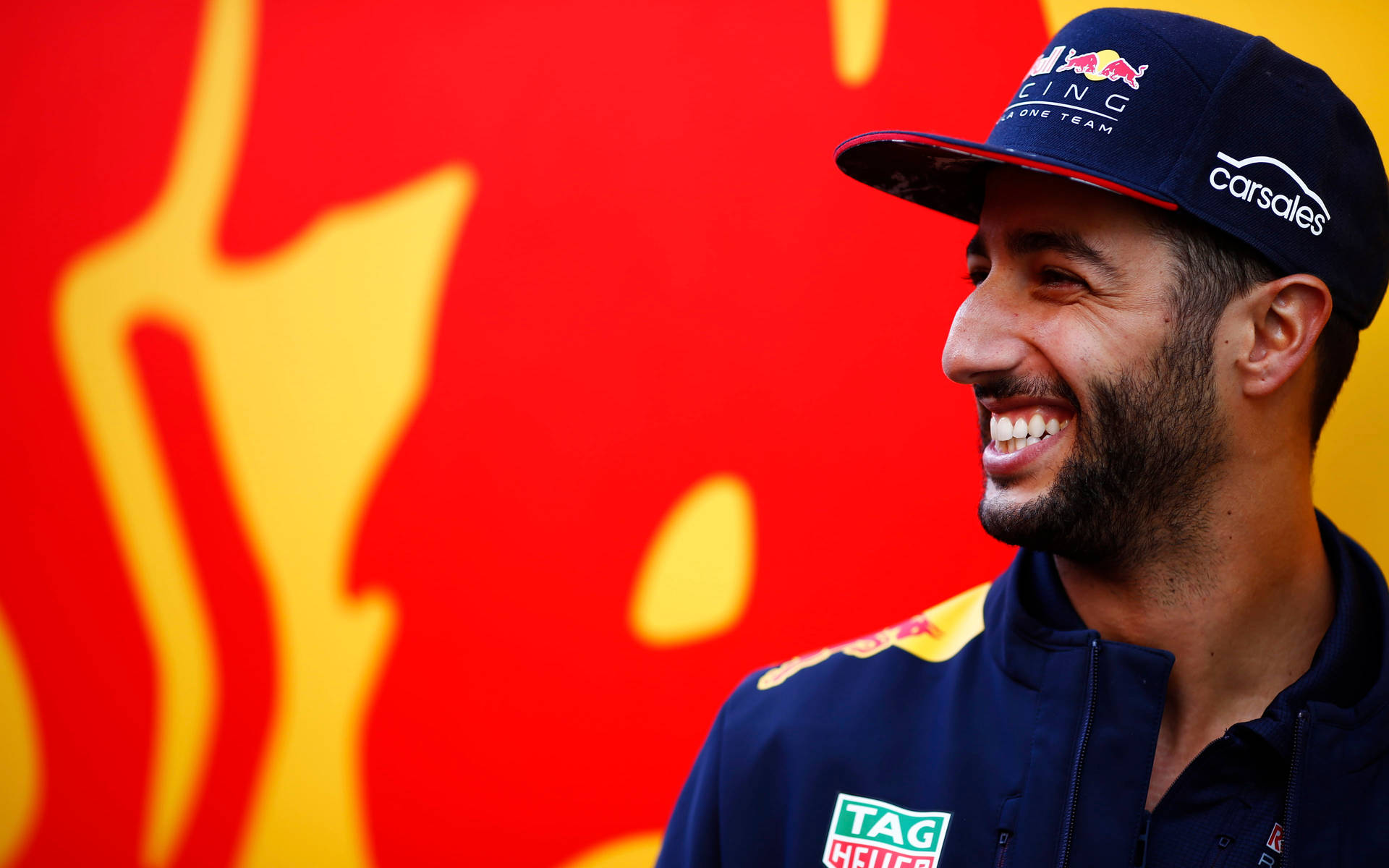 Side-profile Of Daniel Ricciardo Smiling Background