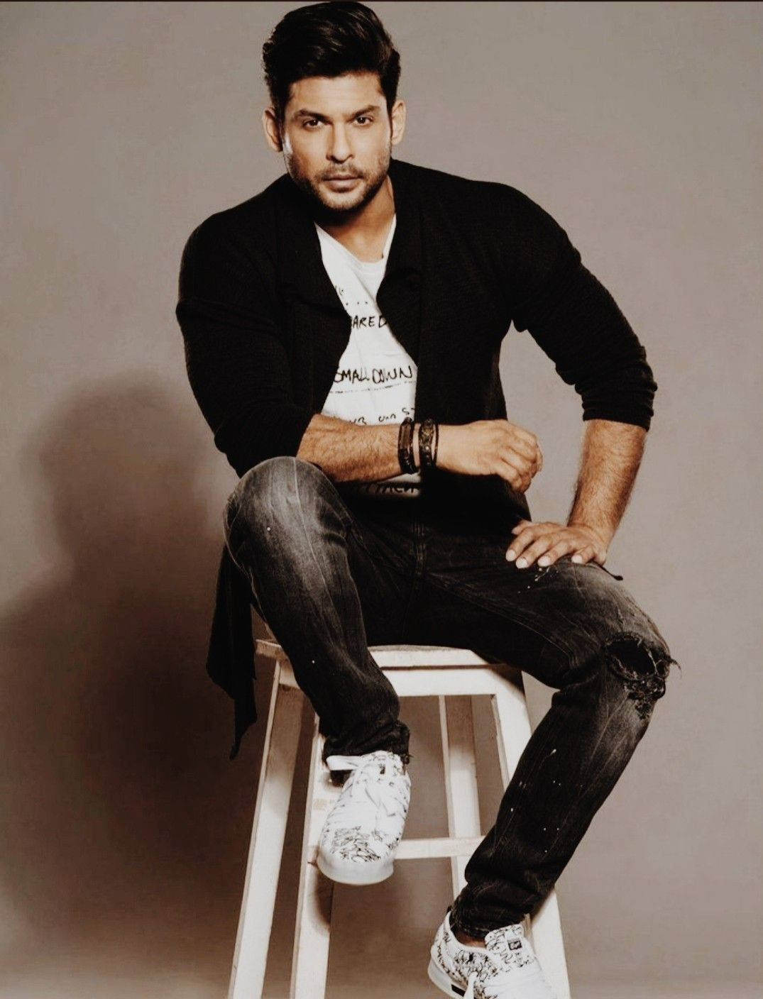 Sidharth Shukla Sitting On A Stool Background