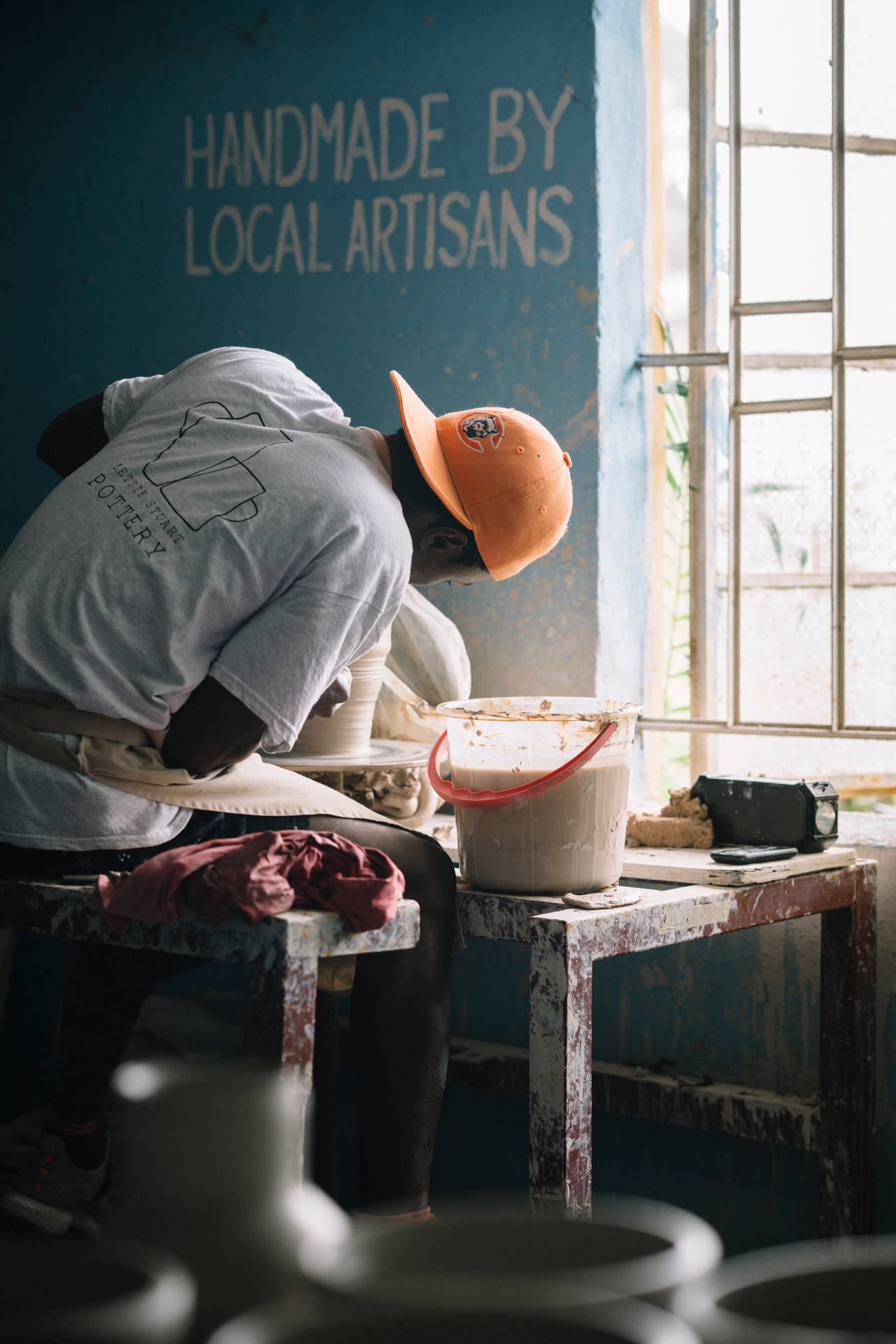 Sierra Leone Man With Back Turned Making Pottery Background