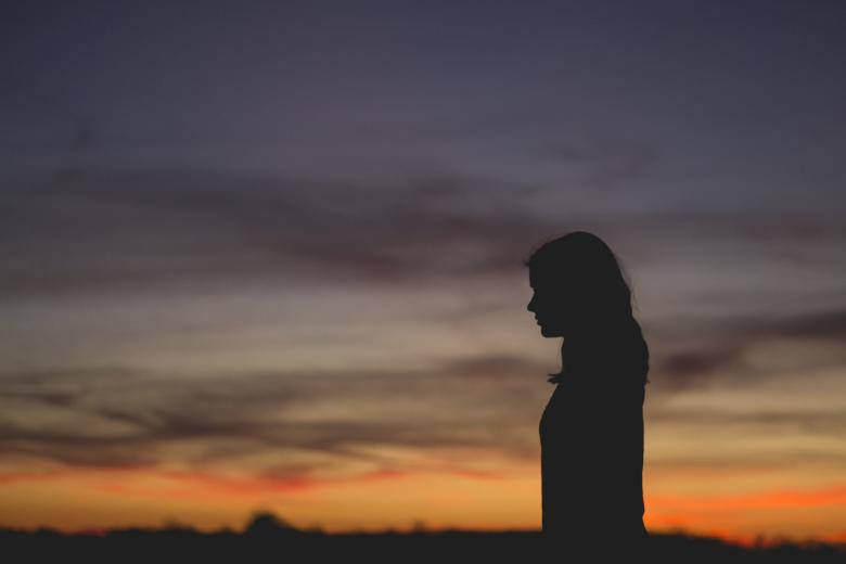 Silhouette Of A Lonely Person During Sunset Background