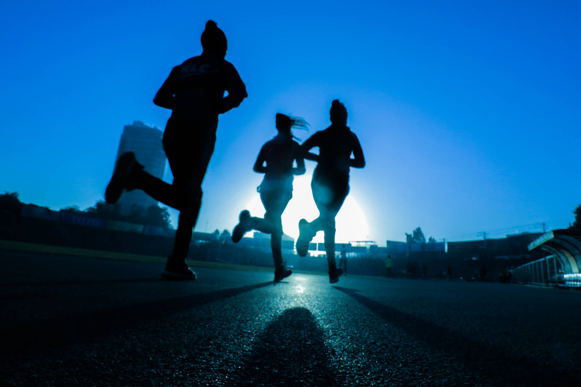 Silhouette Of Fitness Runners Background