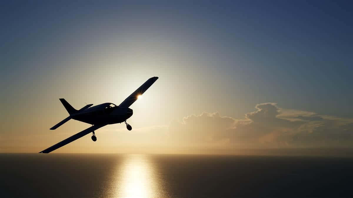 Silhouette Of Small Airplane Above The Water Background