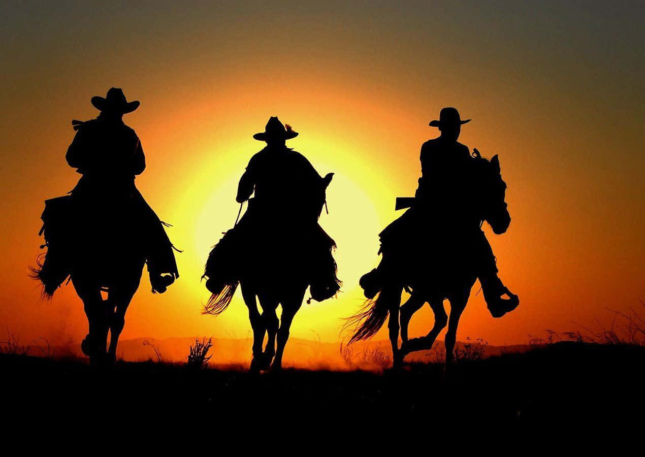Silhouette Of Three Cowboys Riding Horses Background