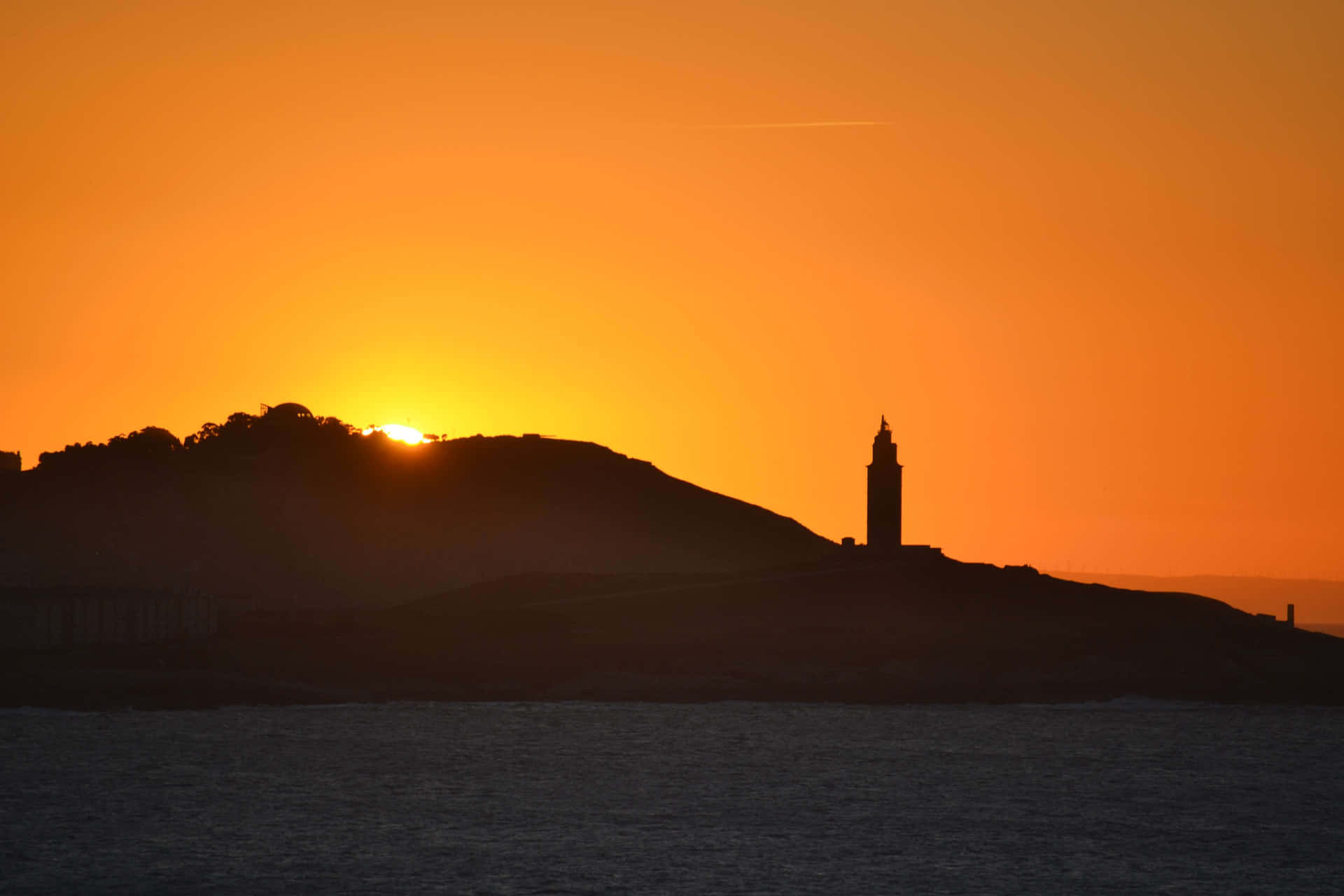 Silhouette Of Tower Of Hercules Orange Sunset Background