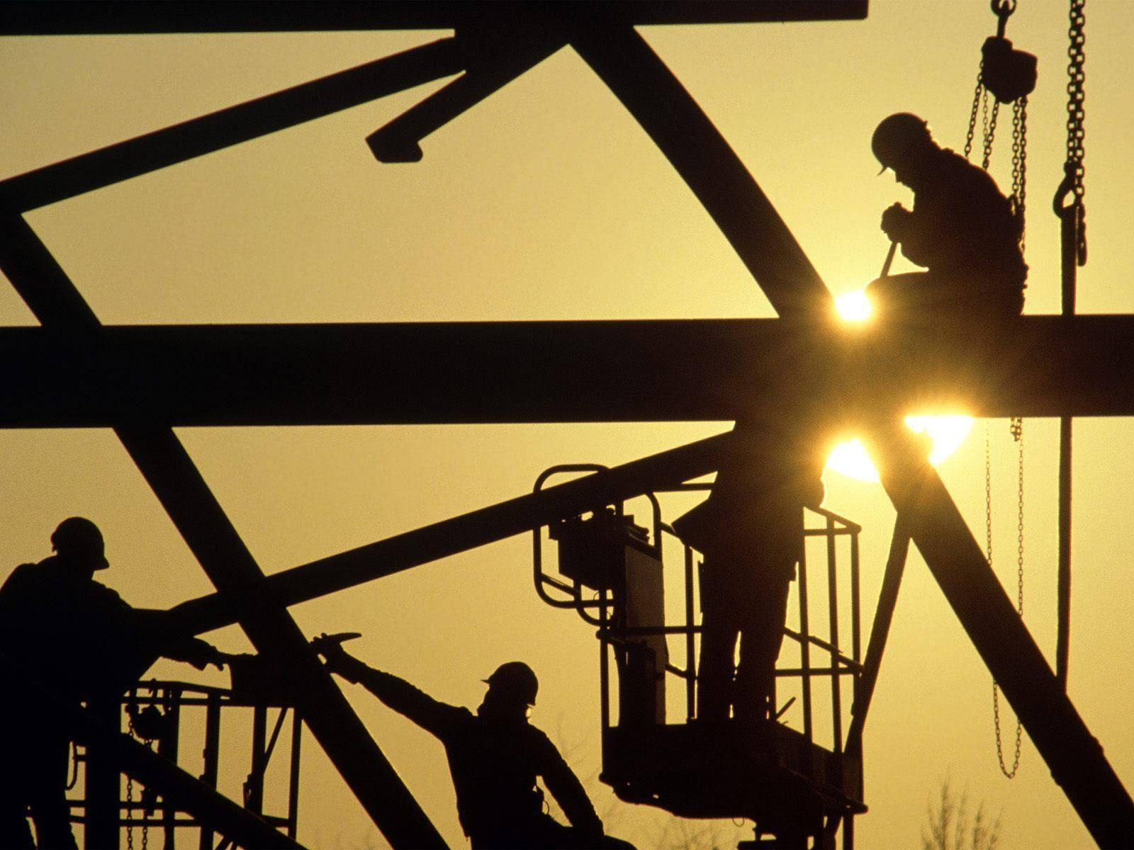 Silhouetted Construction Workers At Work