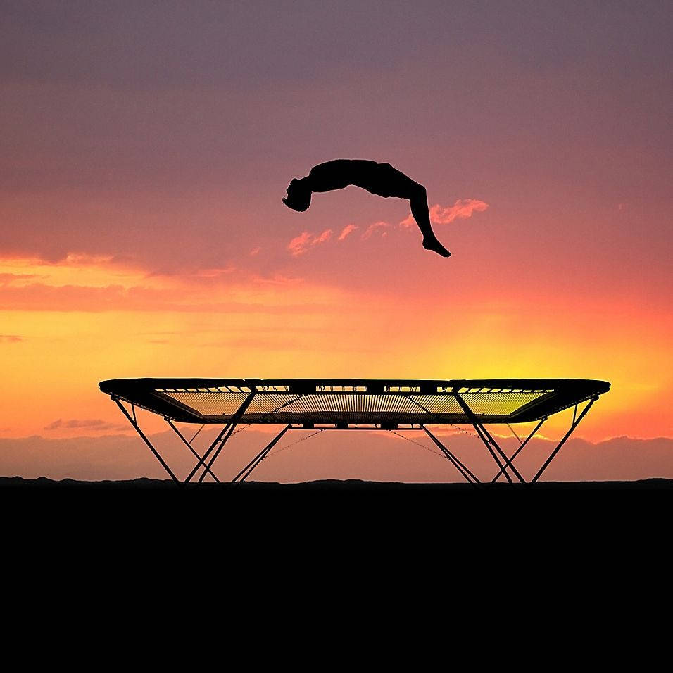 Silhouetted Man And A Trampoline