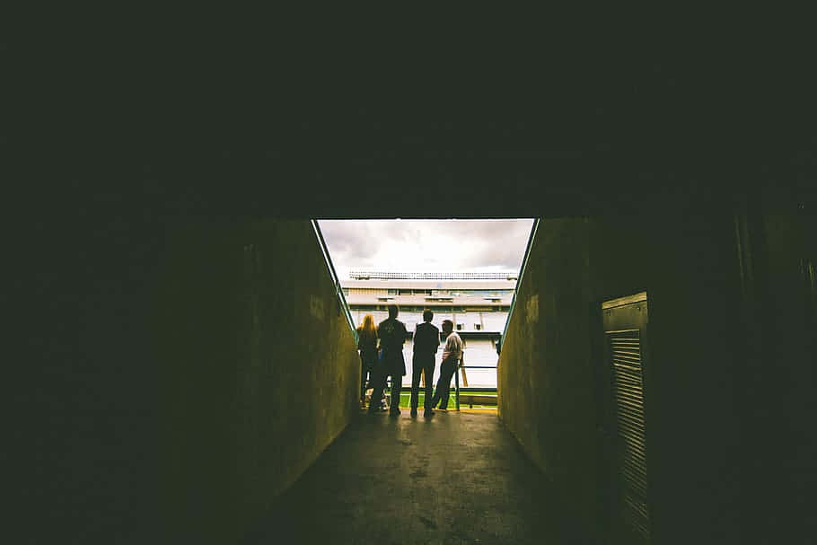 Silhouetted People Exiting Tunnel