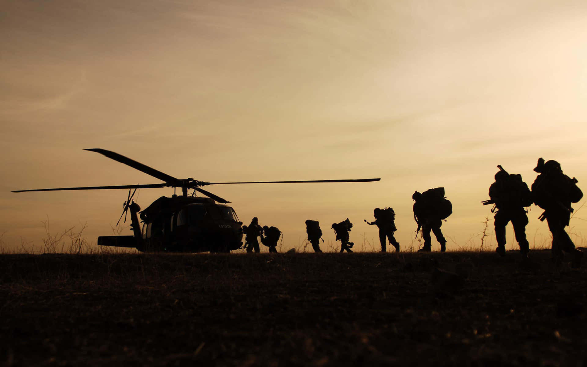 Silhouetted Soldiers Helicopter Sunset Background