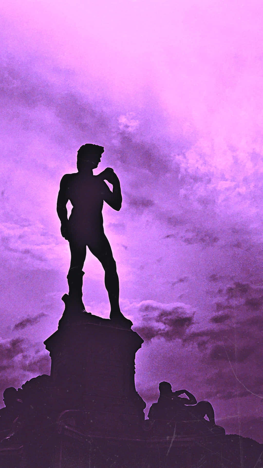 Silhouetted Statue Against Purple Sky Background