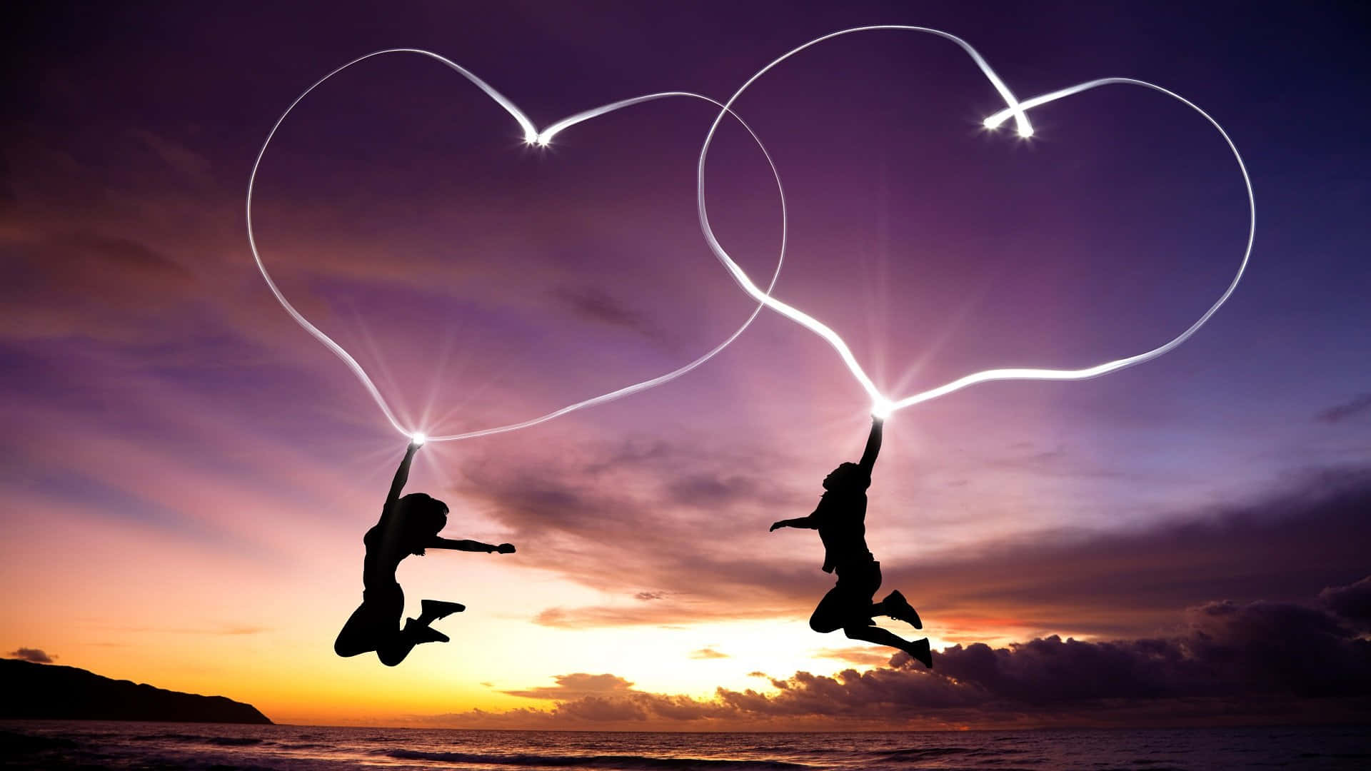 Silhouettes Jumping Heart Trails Sunset Background