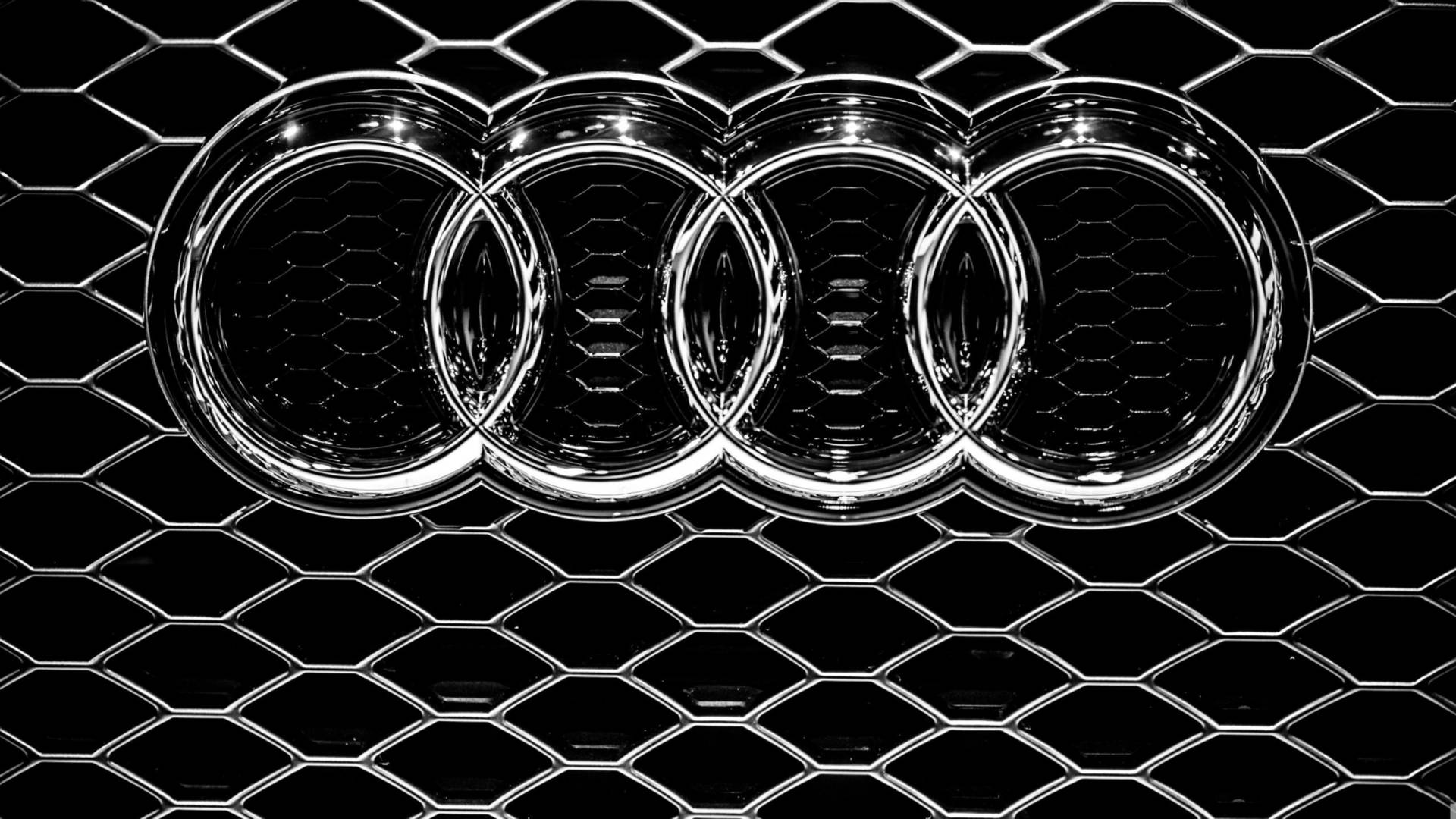 Silver Audi Car Emblem In Solid Black Background