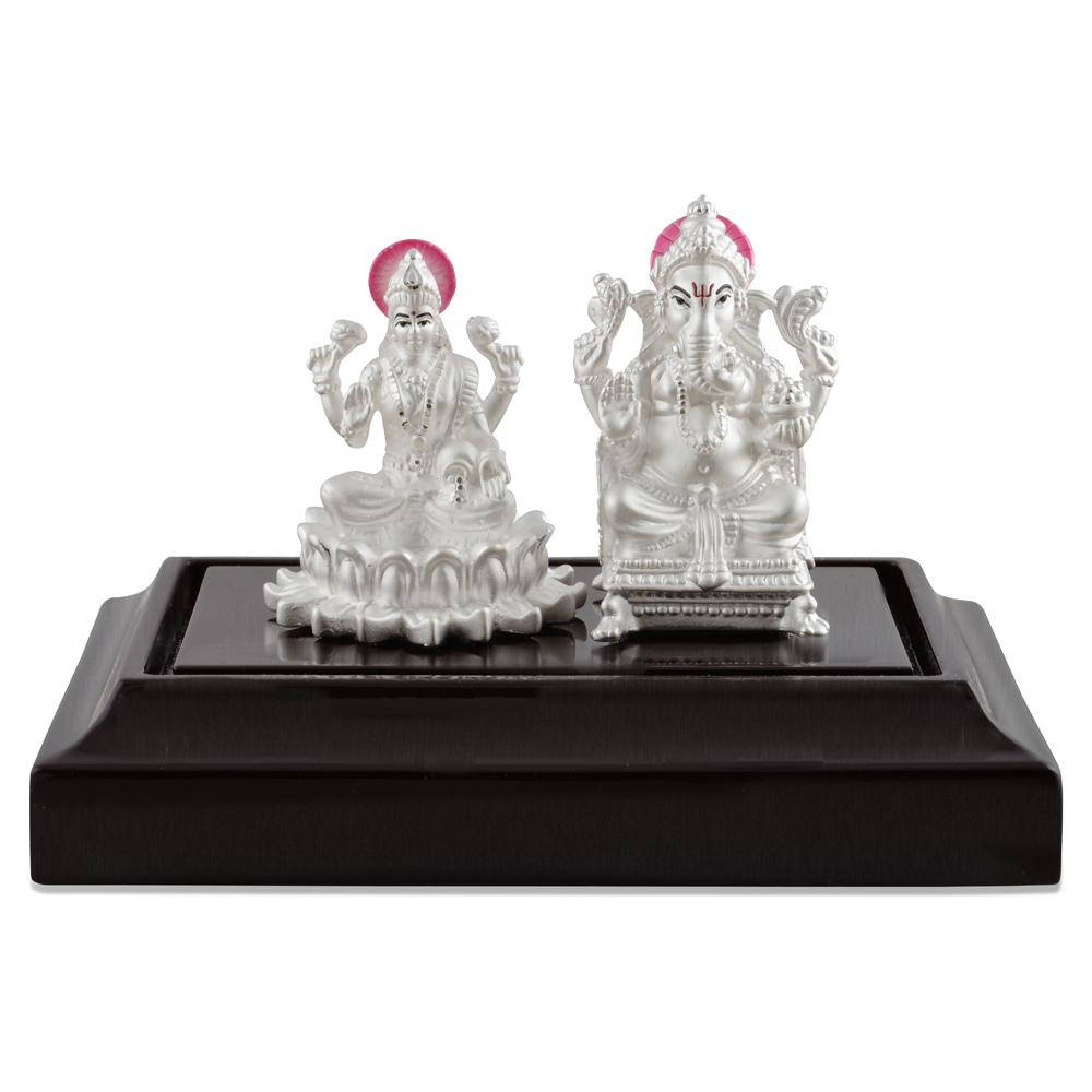 Silver Figurines Of Ganesh Lakshmi Background