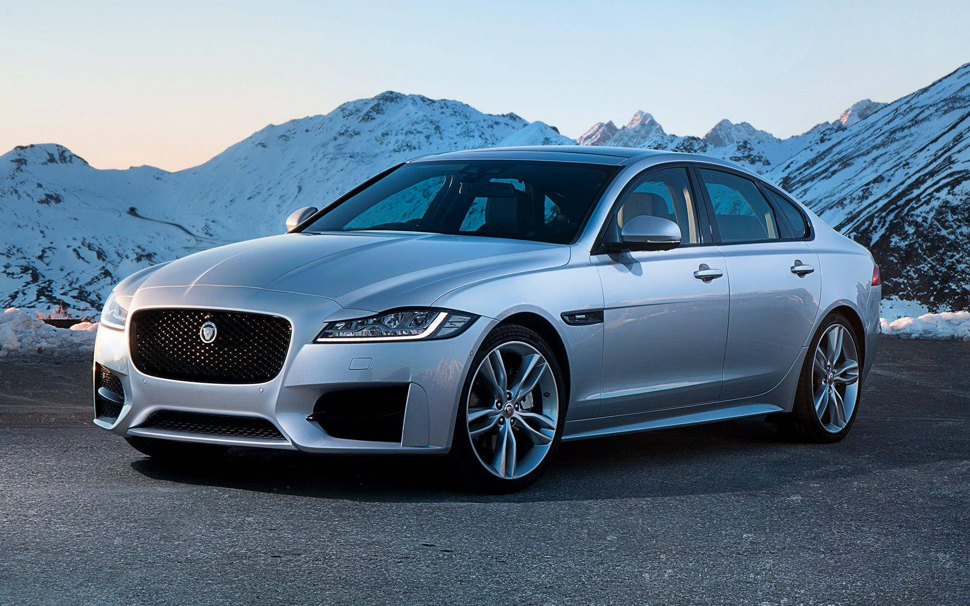 Silver Jaguar Car And Snowy Mountains Background