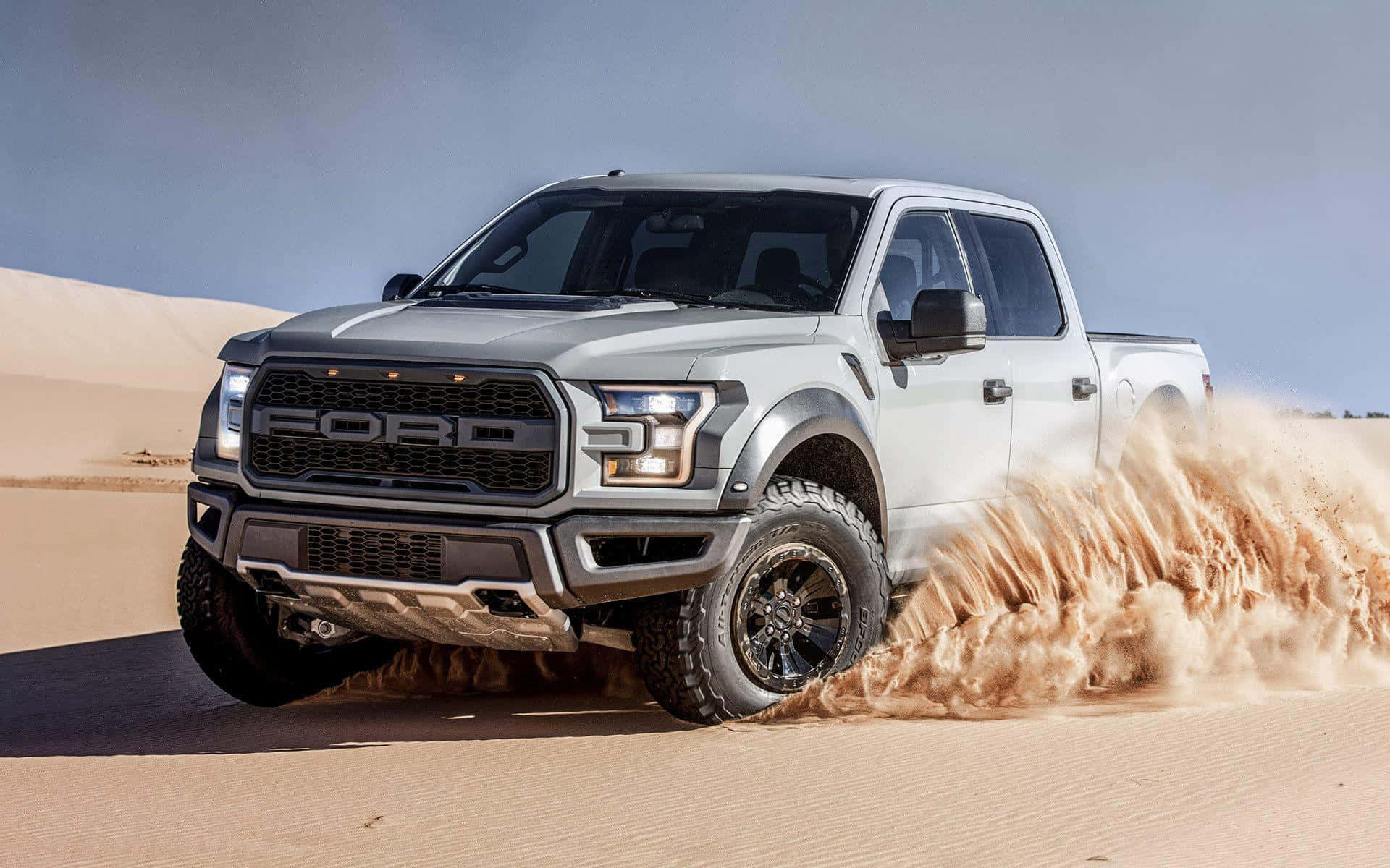 Silver Lifted Truck On Desert Background