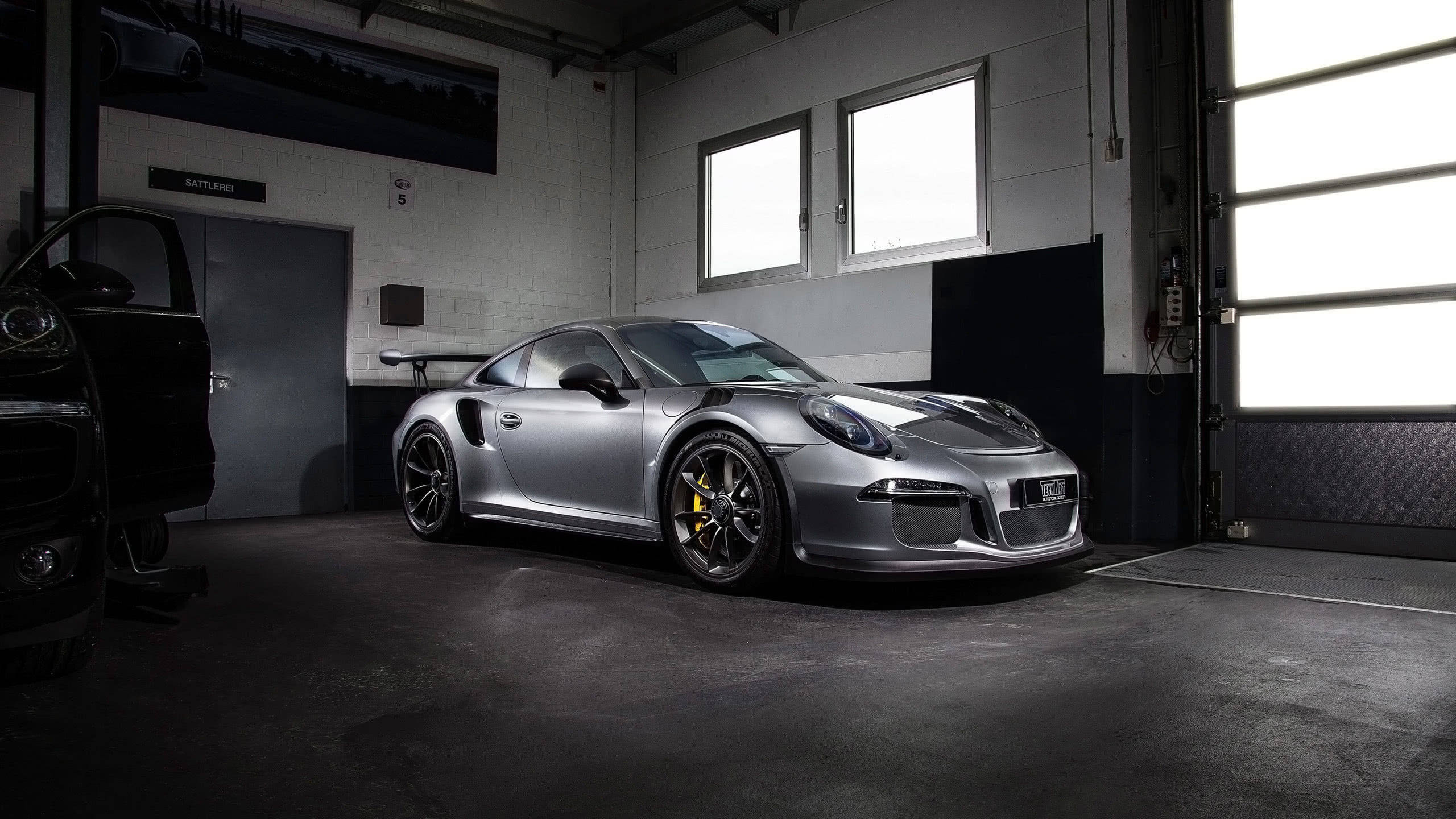 Silver Porsche 911 Parked In Garage Background