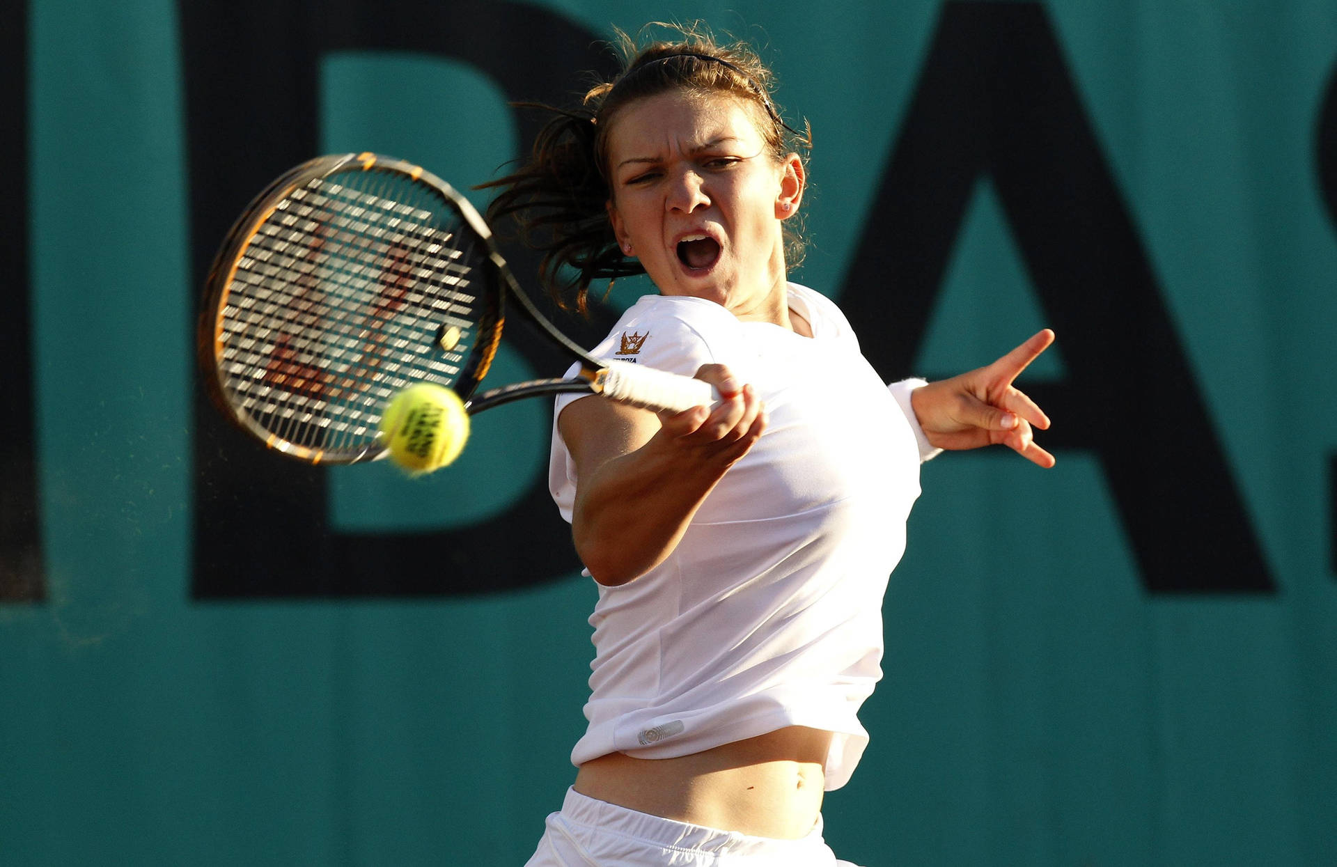 Simona Halep In Action During A Tennis Match Background