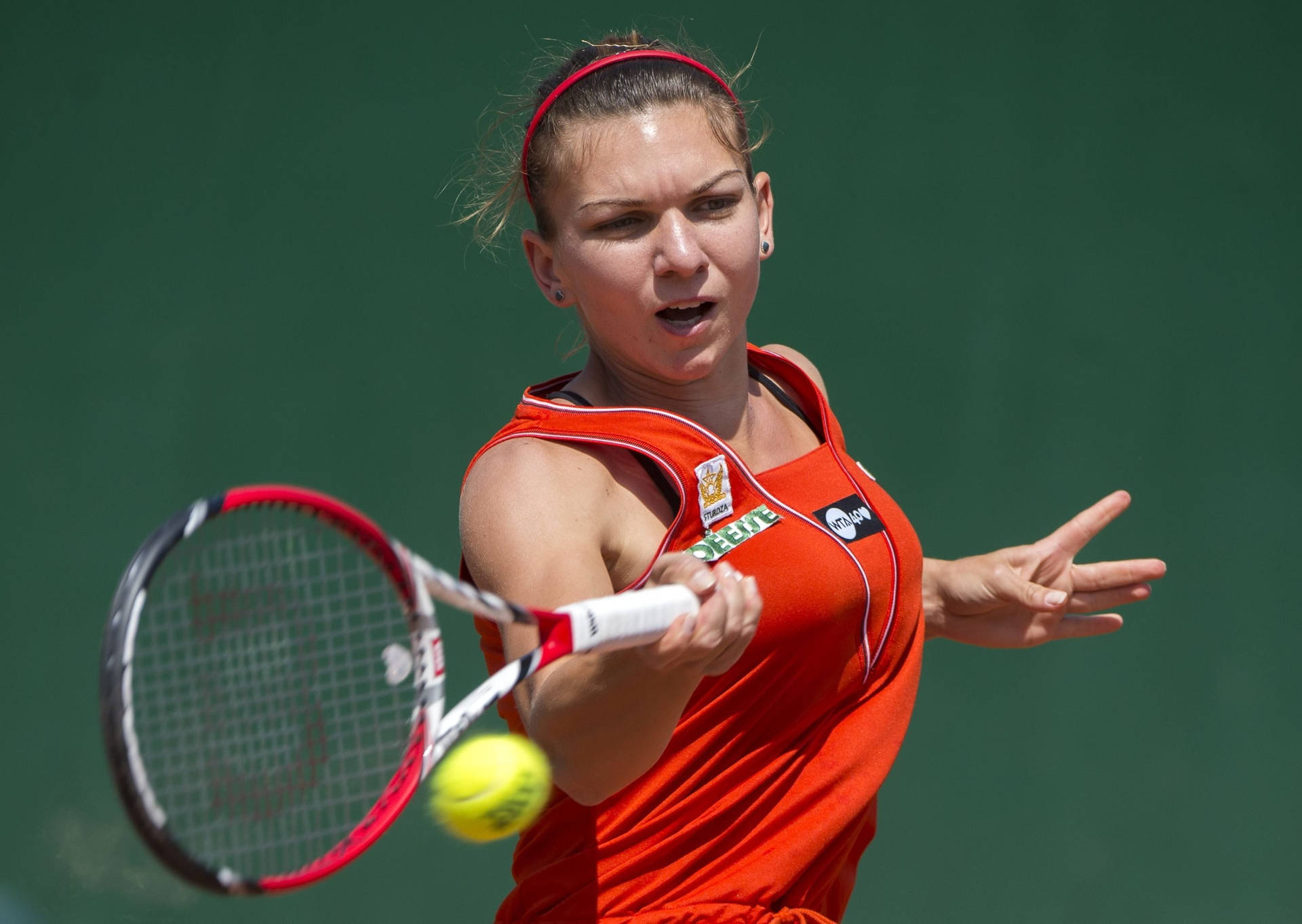 Simona Halep In Action Performing A Powerful Forehand.