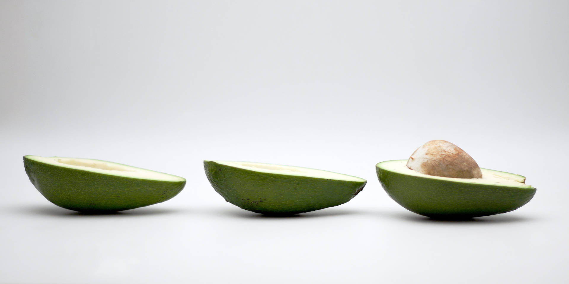 Simple Avocado Fruit In Halves Display Background