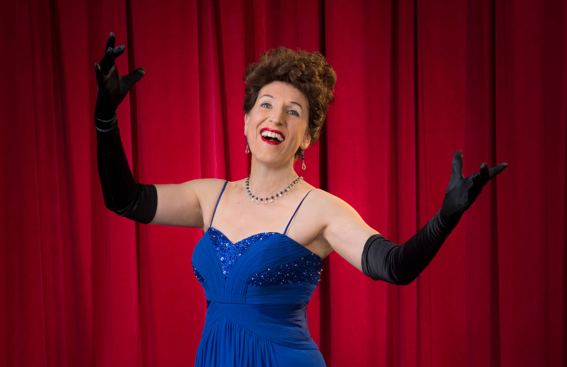 Singer Ethel Merman On Stage In A Blue Dress Background