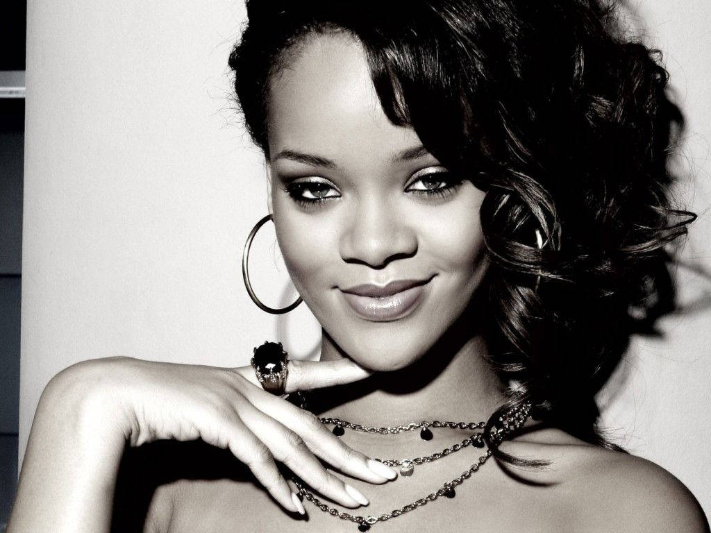 Singer Rihanna Shows Off Her Playful Attitude In This Classic Black And White Portrait. Background