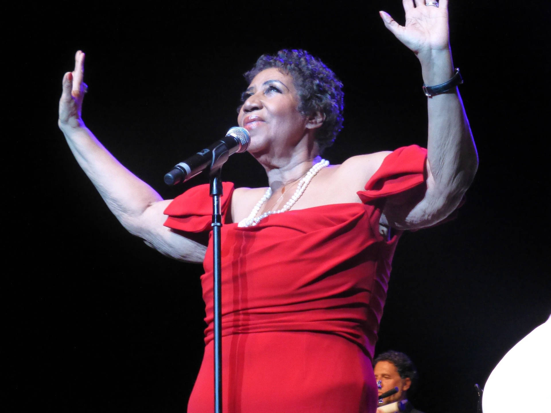 Singer-songwriter And Pianist Aretha Franklin In Red Background