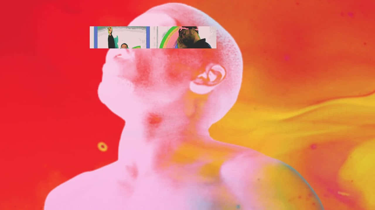 Singer-songwriter Frank Ocean Leaning Back In A Chair, Typing On His Laptop