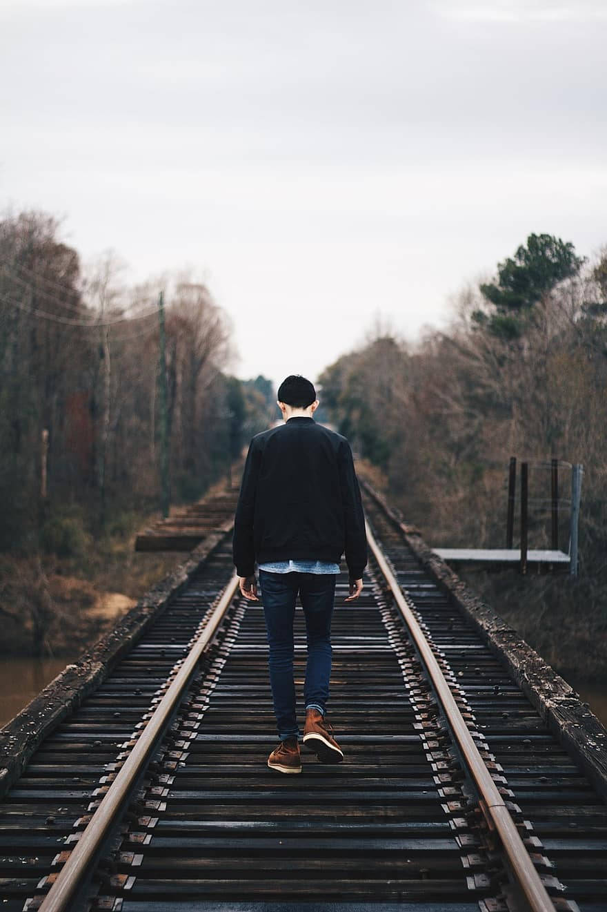 Single Boy Walking On A Railway Background