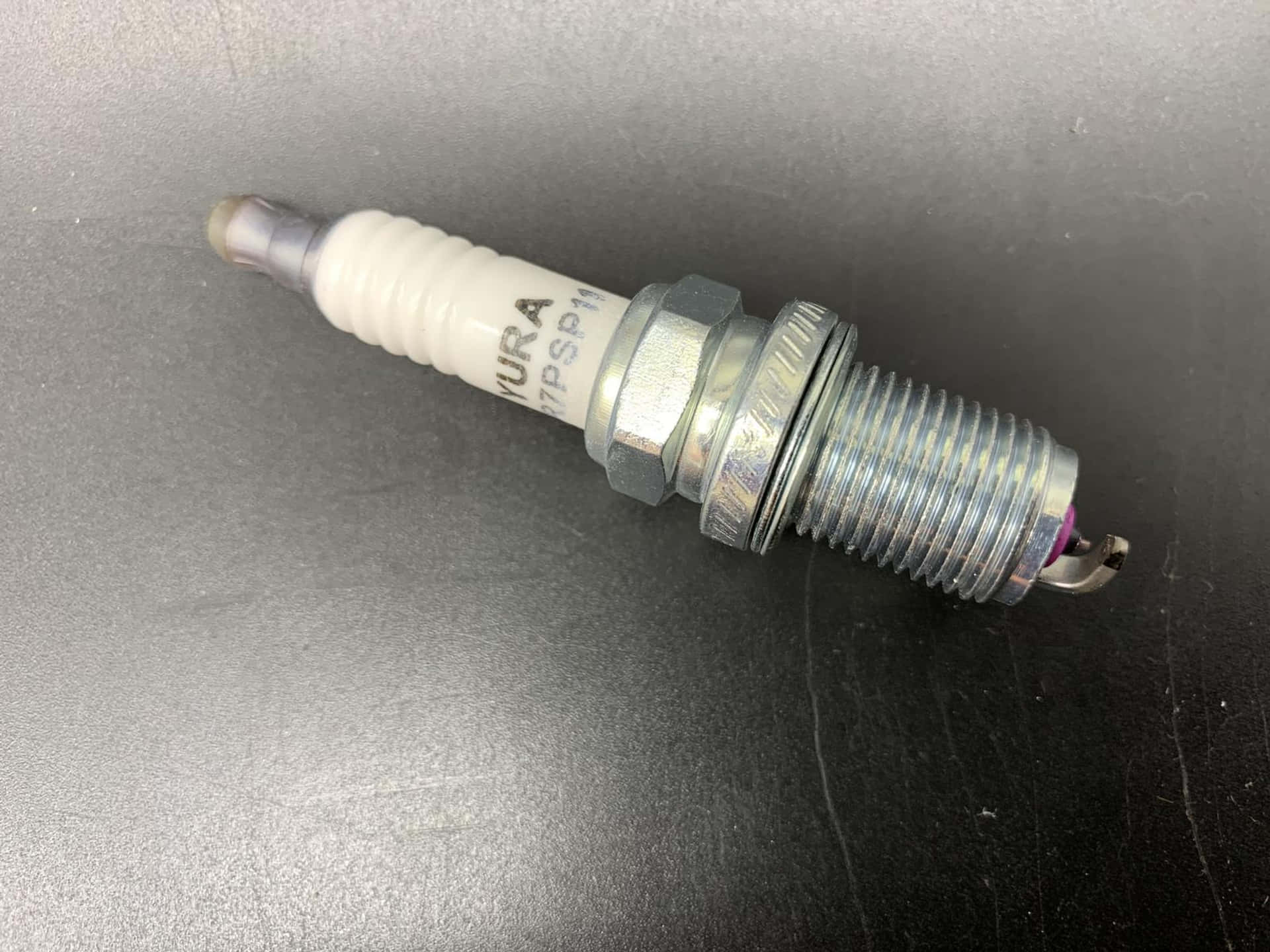 Single Honda Spark Plug Background