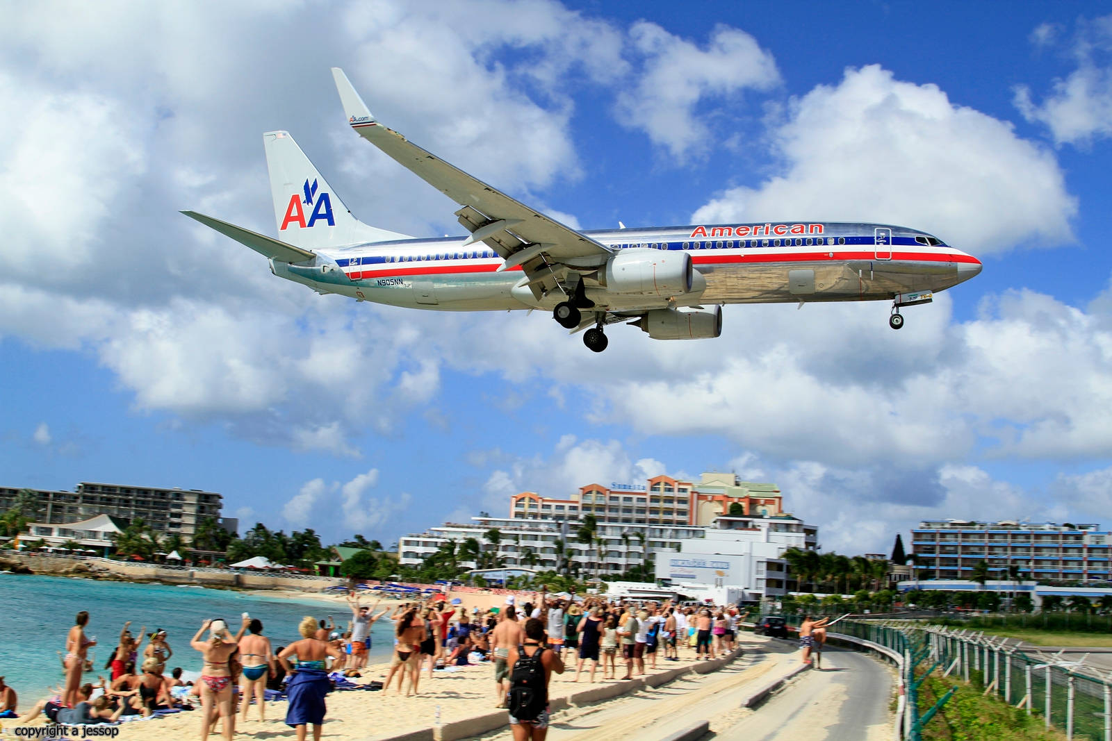 Sint Maarten Tourists Stunned By A Landing Plane Background