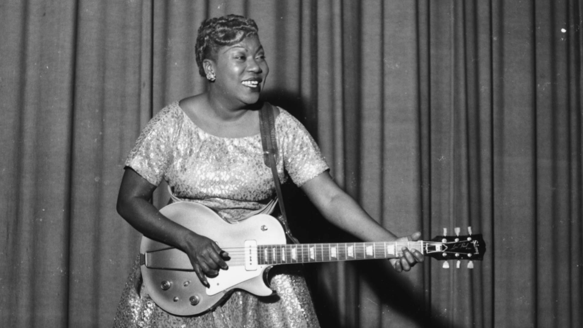 Sister Rosetta Tharpe Joyfully Playing Guitar Background