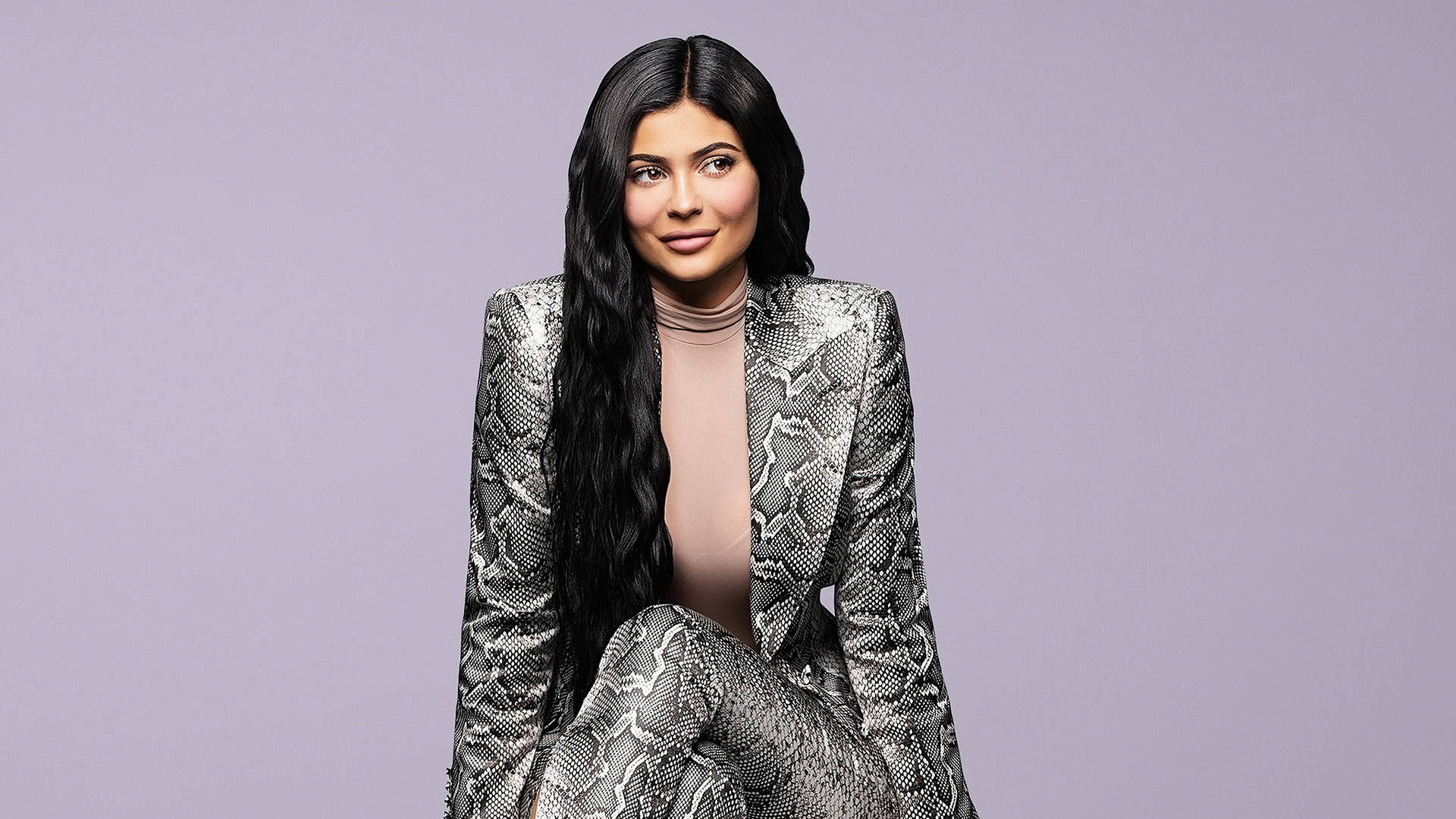 Sitting Kylie Jenner In Snakeskin Suit