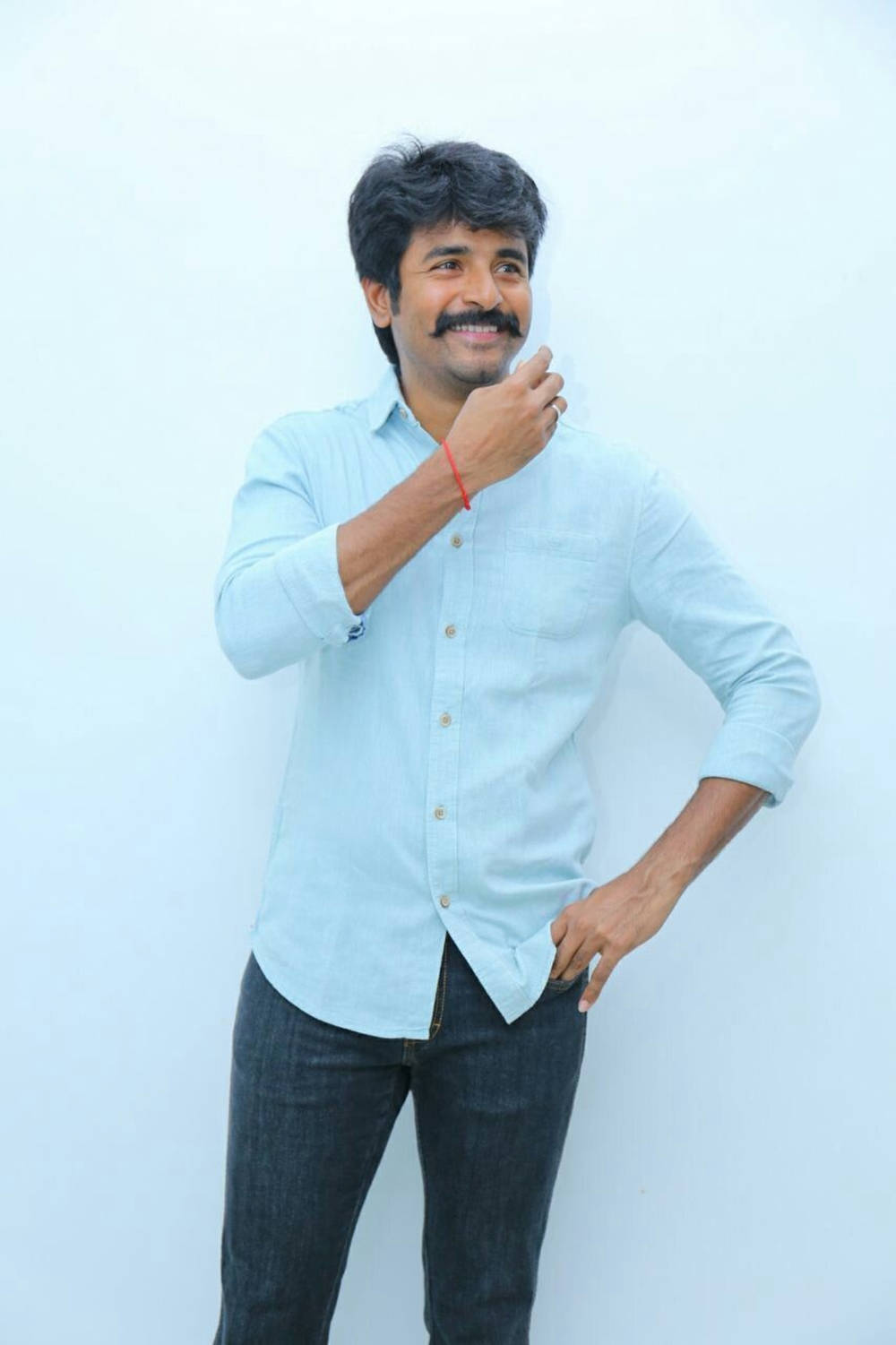 Sivakarthikeyan Posing In A Light-blue Shirt Background