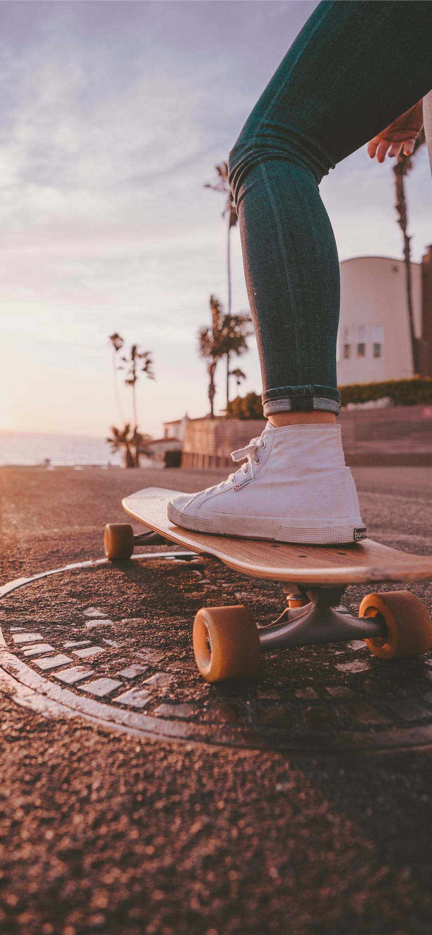 Skateboard Above A Manhole Cover Sports Iphone Background